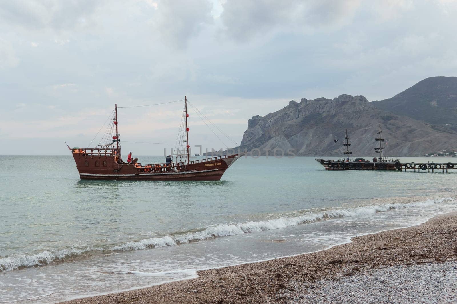 Sailing ship sailing to the shore, marine tourism. Beach holidays on the Black Sea. Fabulous moments of a sunny day