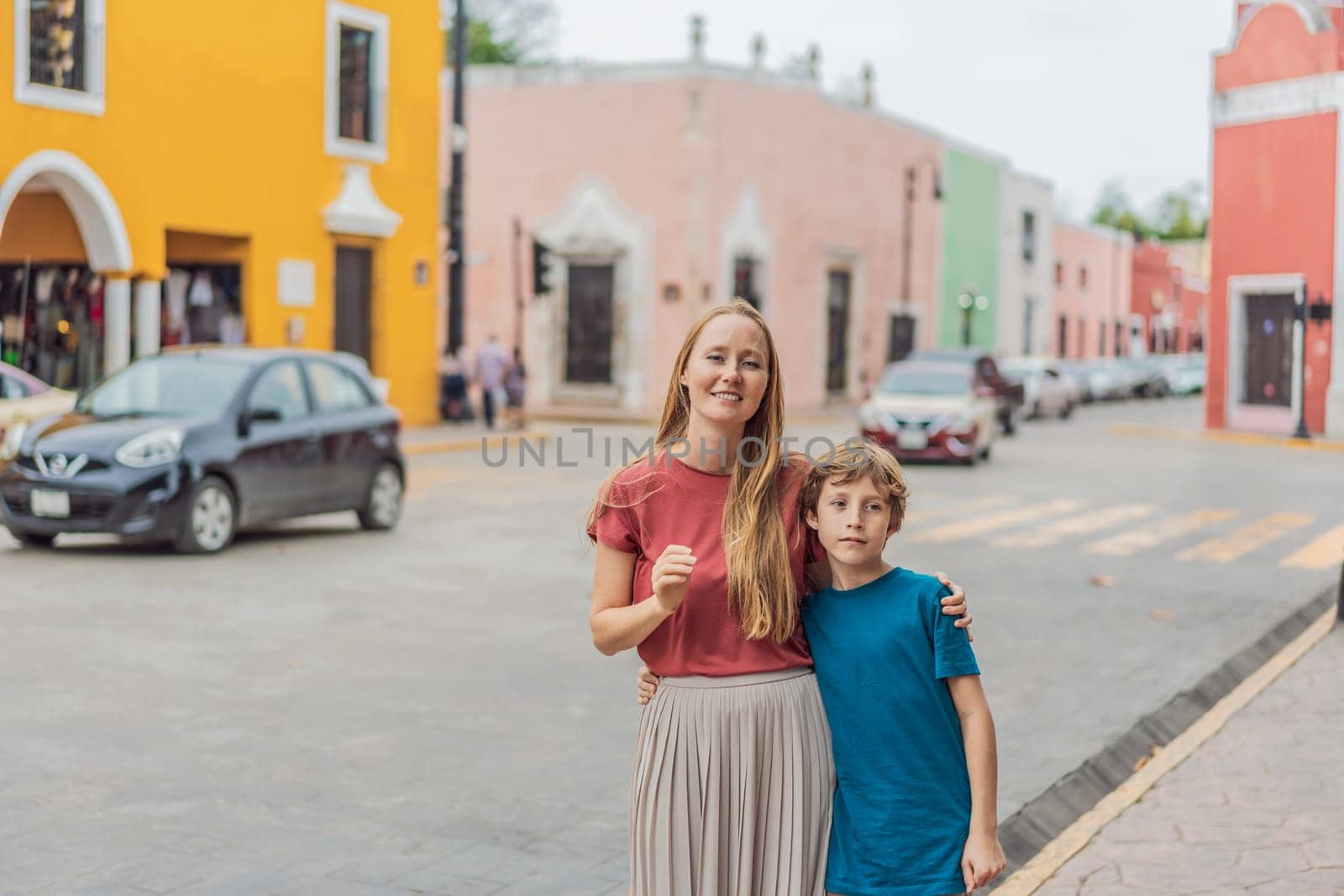 Mother and son tourists explore the vibrant streets of Valladolid, Mexico, immersing herself in the rich culture and colorful architecture of this charming colonial town by galitskaya