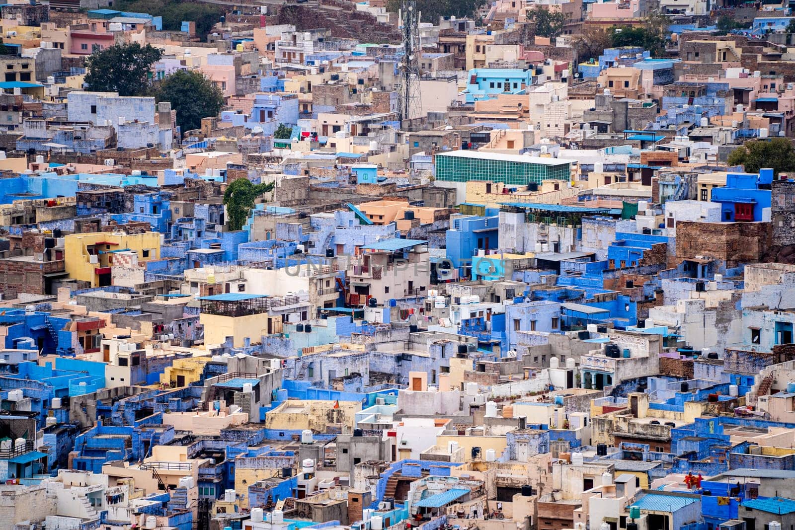 aerial drone shot showing jodhpur blue city cityscape showing traditional houses in middle of aravalli with colorful densely packed houses India