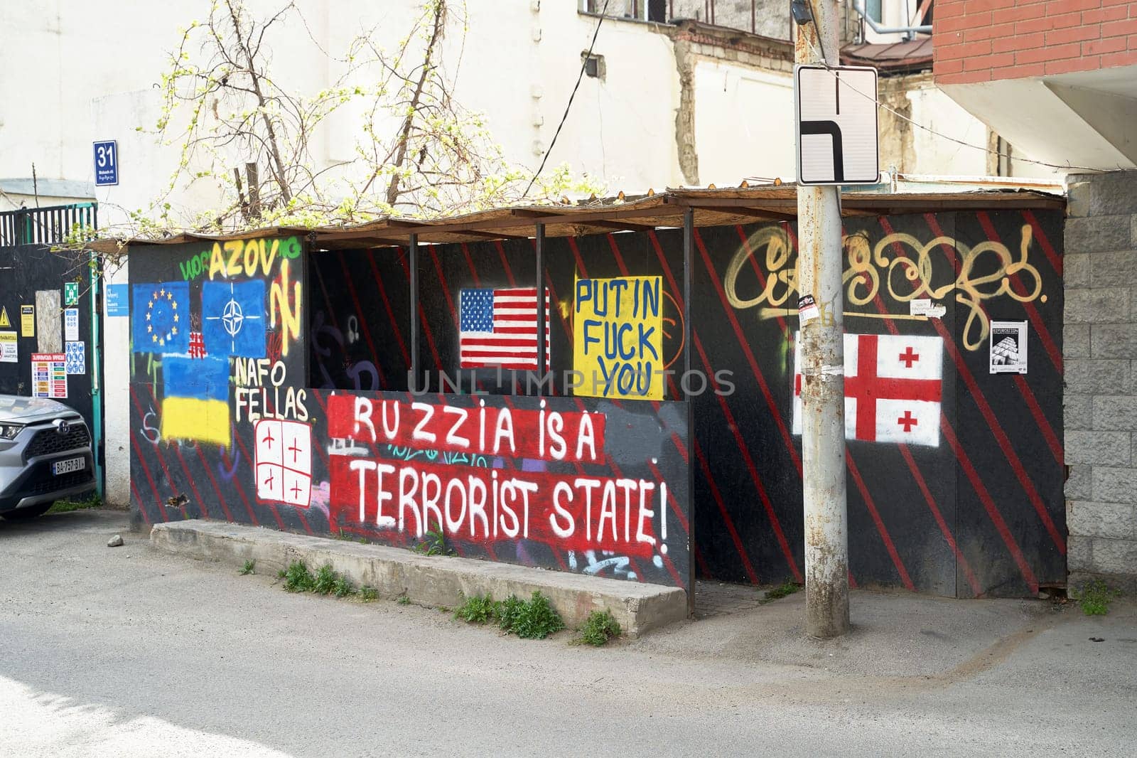 Tbilisi, Georgia - April 17, 2024: Anti-Russian, pro-Ukrainian, and pro-NATO writings on the bus stop.