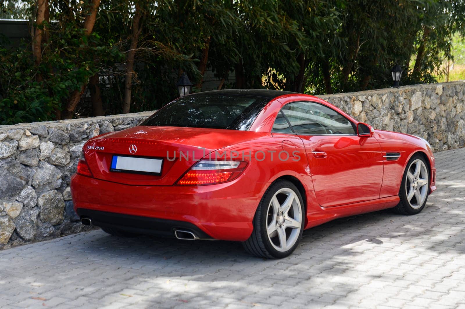 Gaziveren Cyprus 04.18.2024-red Mercedes Benz SLK 250 in the parking lot near the house 1