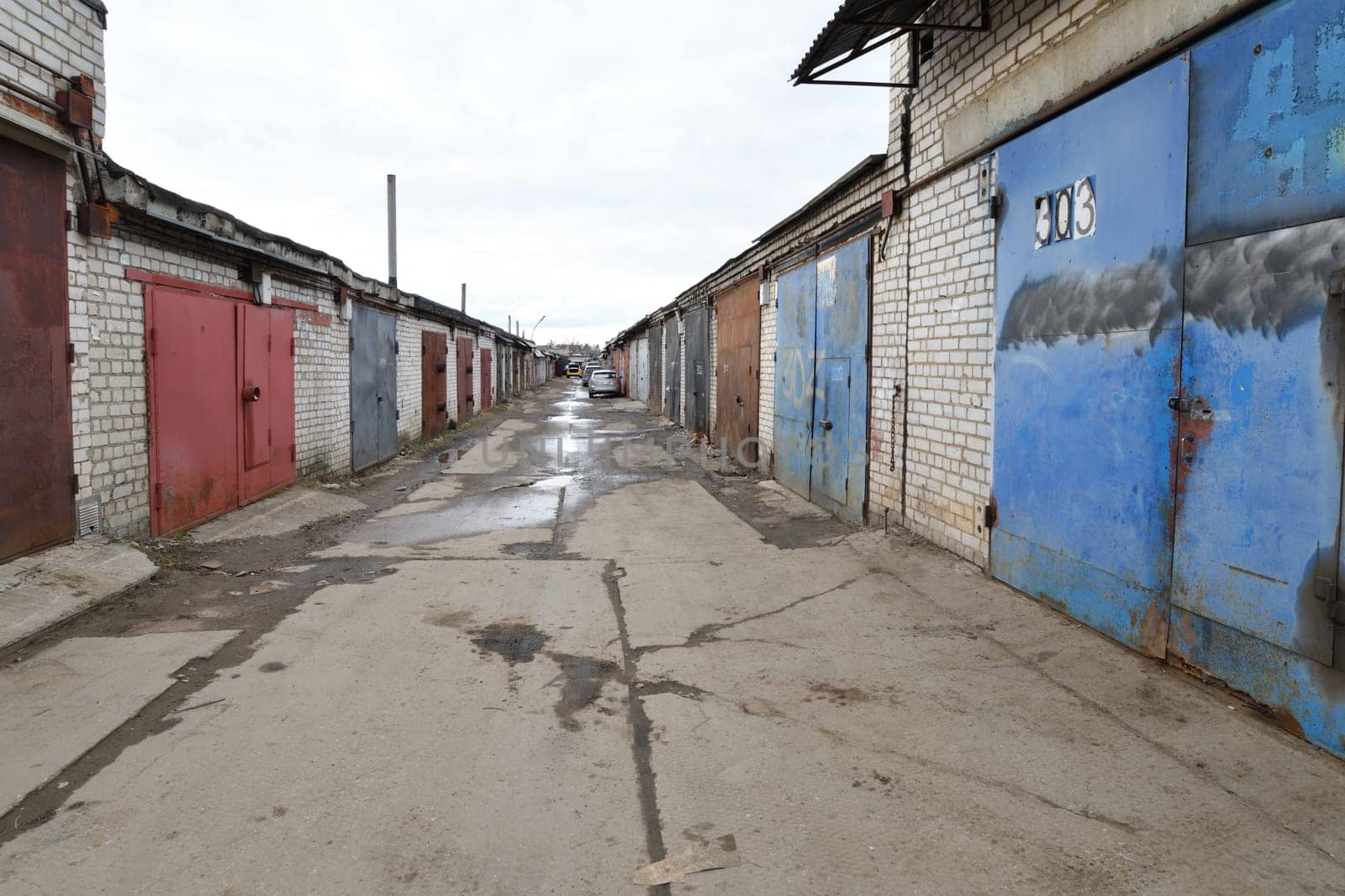 Brick garages with a metal gates of garage cooperative in Russia