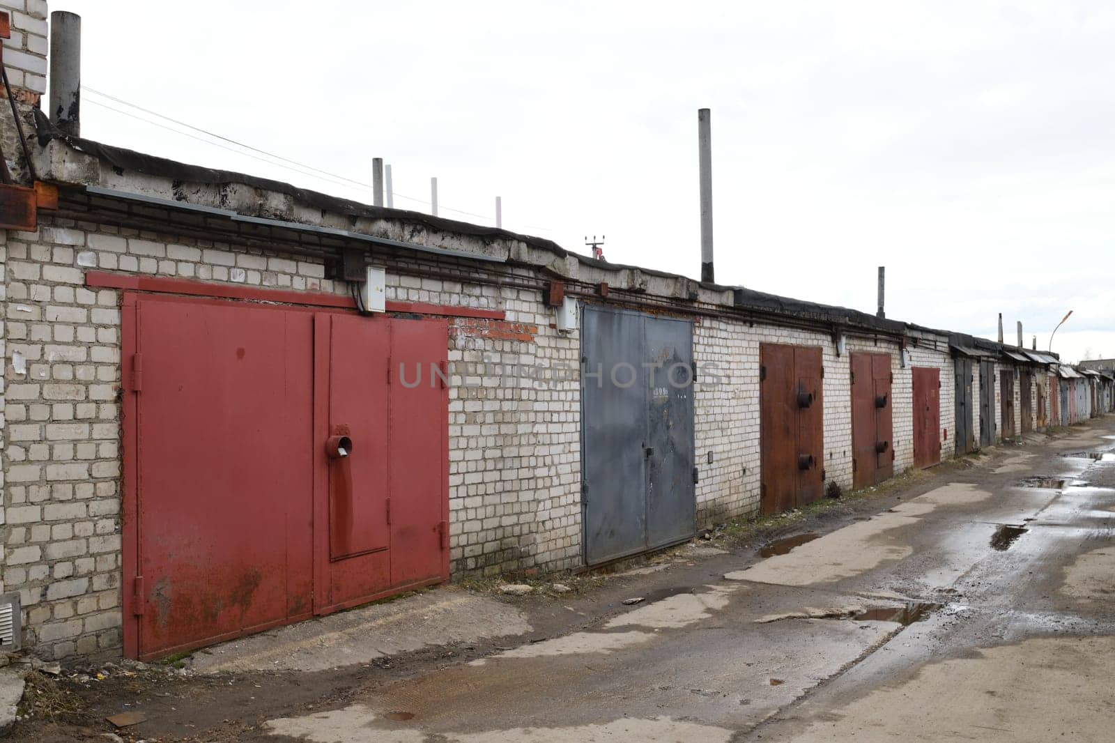 Brick garages with metal gates of garage cooperative in Russia by olgavolodina