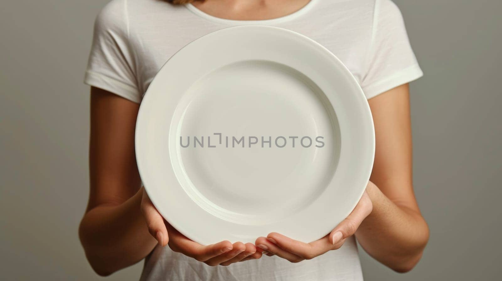 A woman holding a white plate in her hands