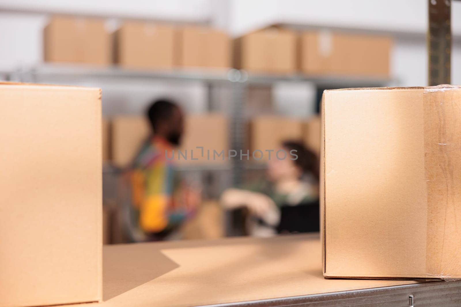 Selective focus of cardboard boxes in warehouse by DCStudio