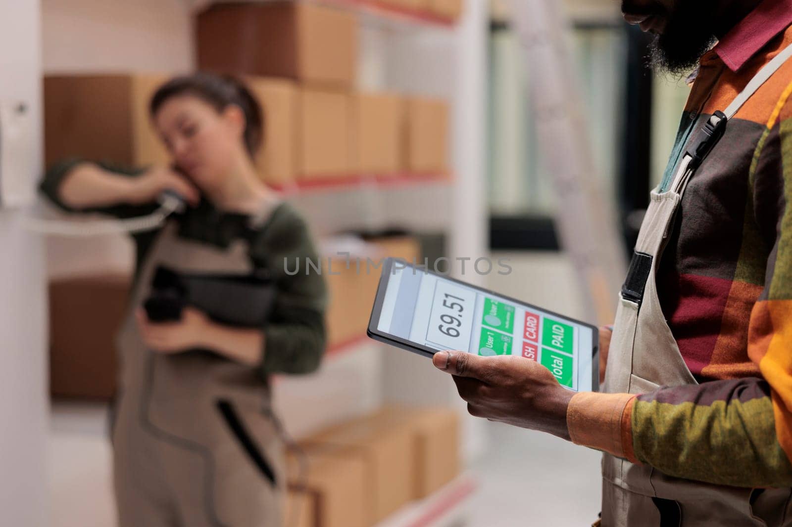 Warehouse supervisor holding tablet computer by DCStudio