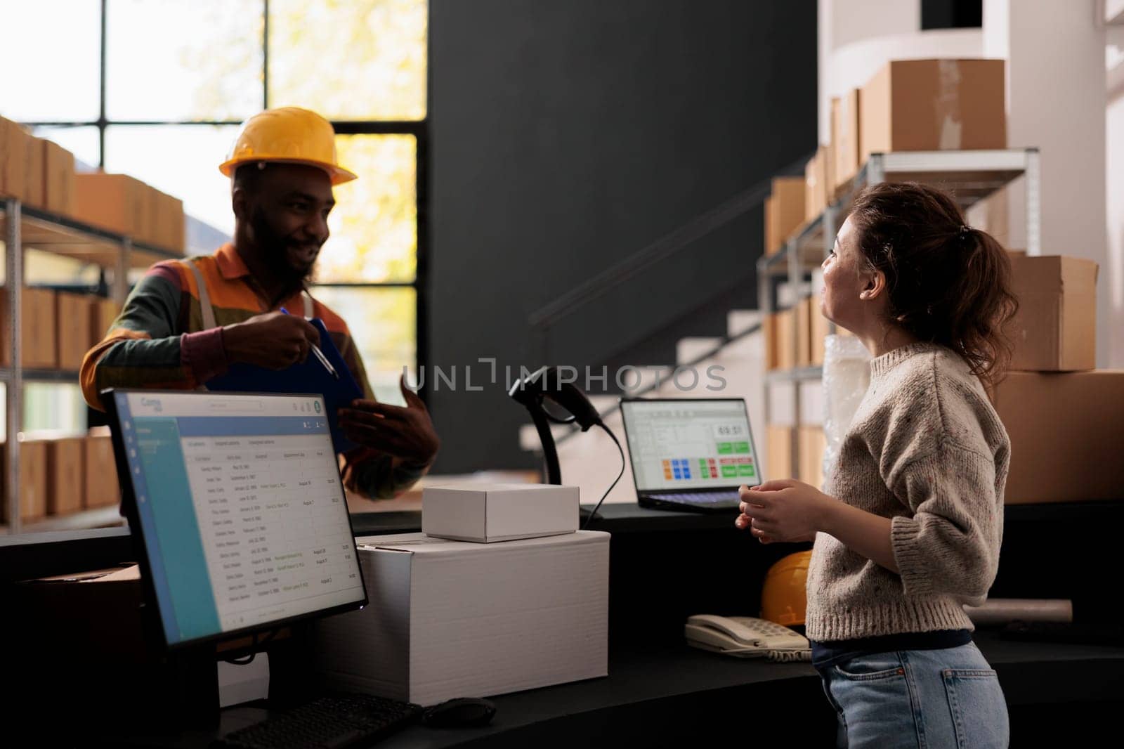 Storage room worker showing papers with customers orders by DCStudio