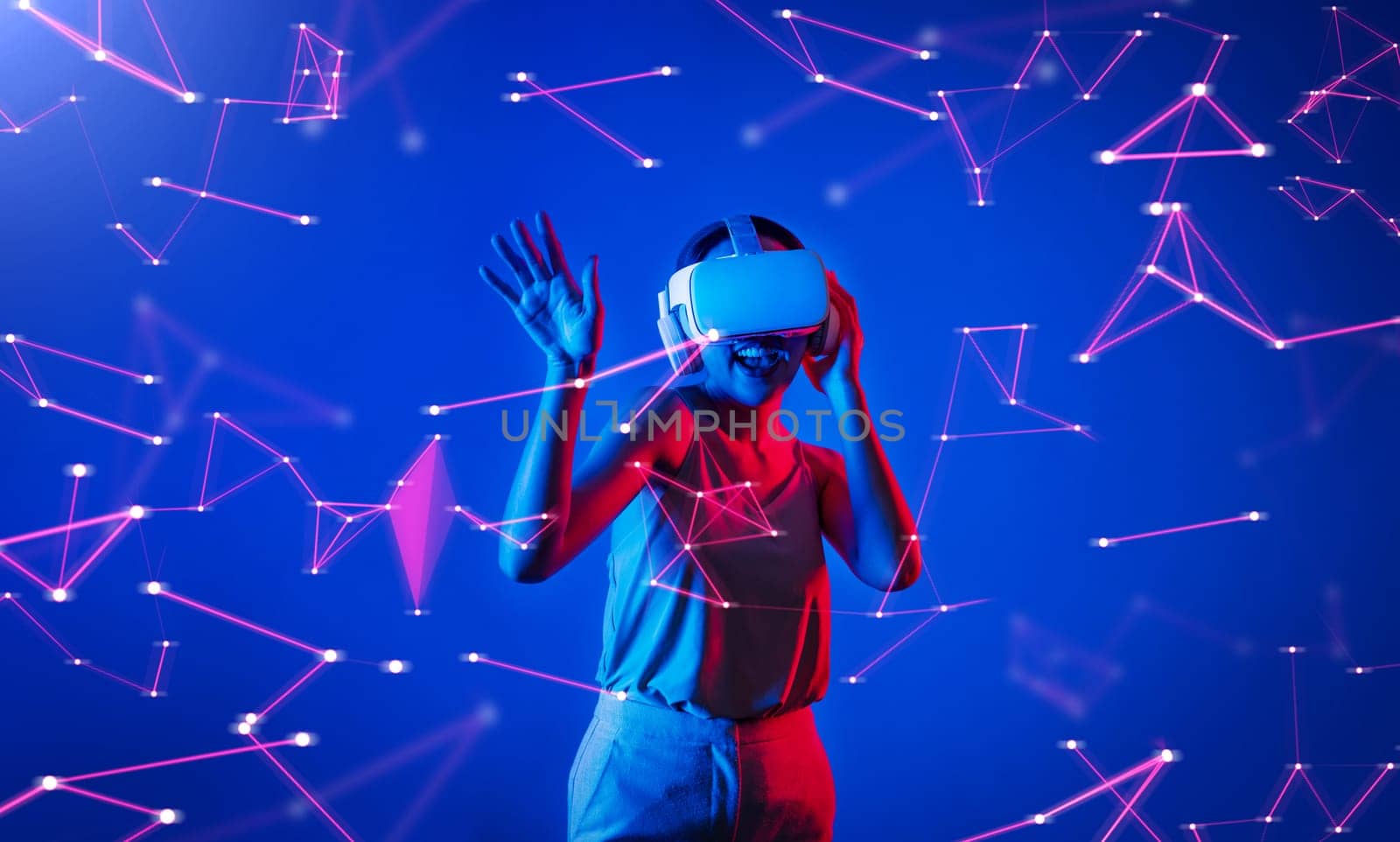 Female standing wearing white VR headset and tank top connecting metaverse, future cyberspace community technology, enjoy dancing in cyberpunk neon light gesticulate hand and body. Hallucination.