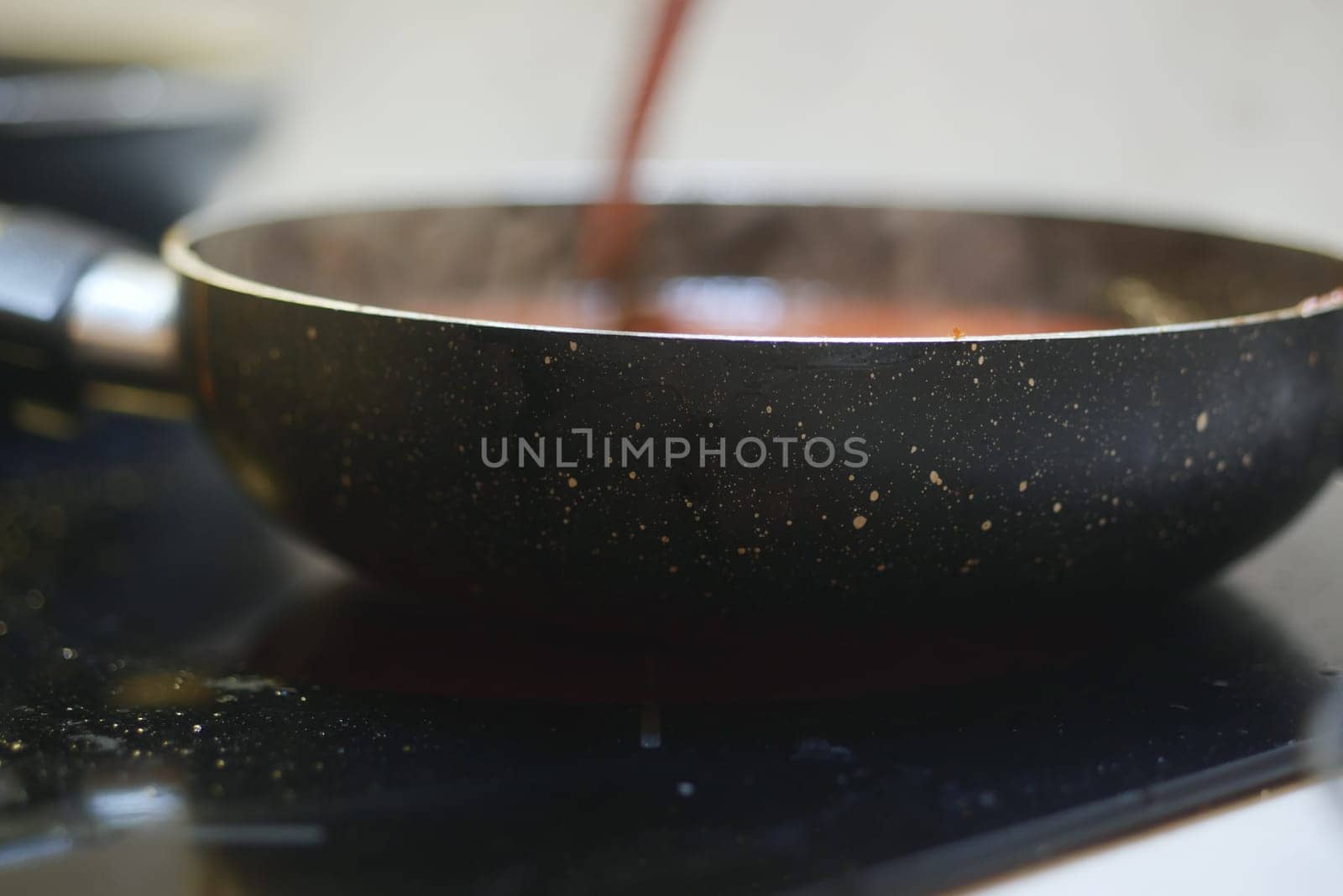 cooking pan on electric stove, electric stove is heated to red. by towfiq007