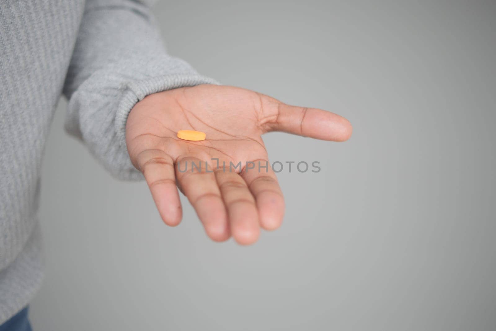 Close up of man hand holding pills with copy space .