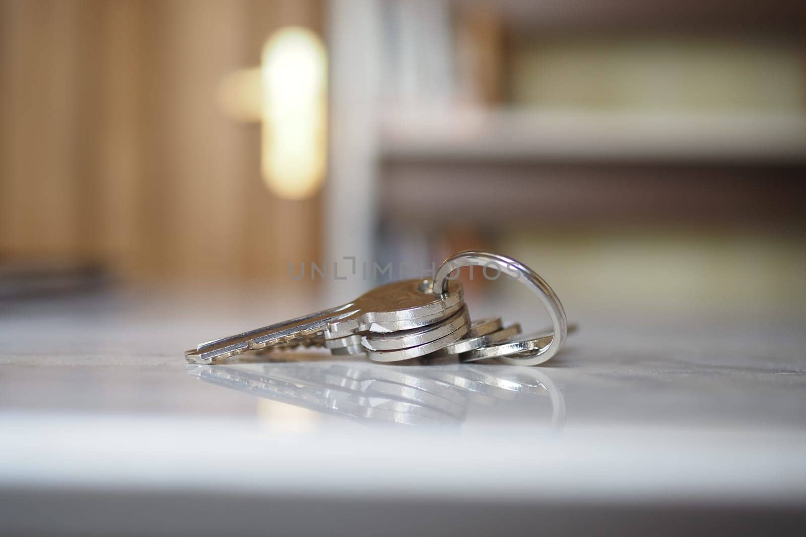house keys on the ring on table in a room. Bunch of apartment keys. To forget keys at home concept ,