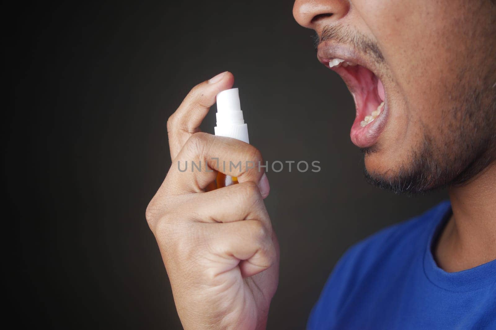 Man Applying Fresh Breath Spray