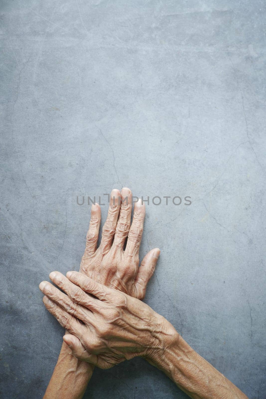 top view of hands of a elderly person on black background by towfiq007