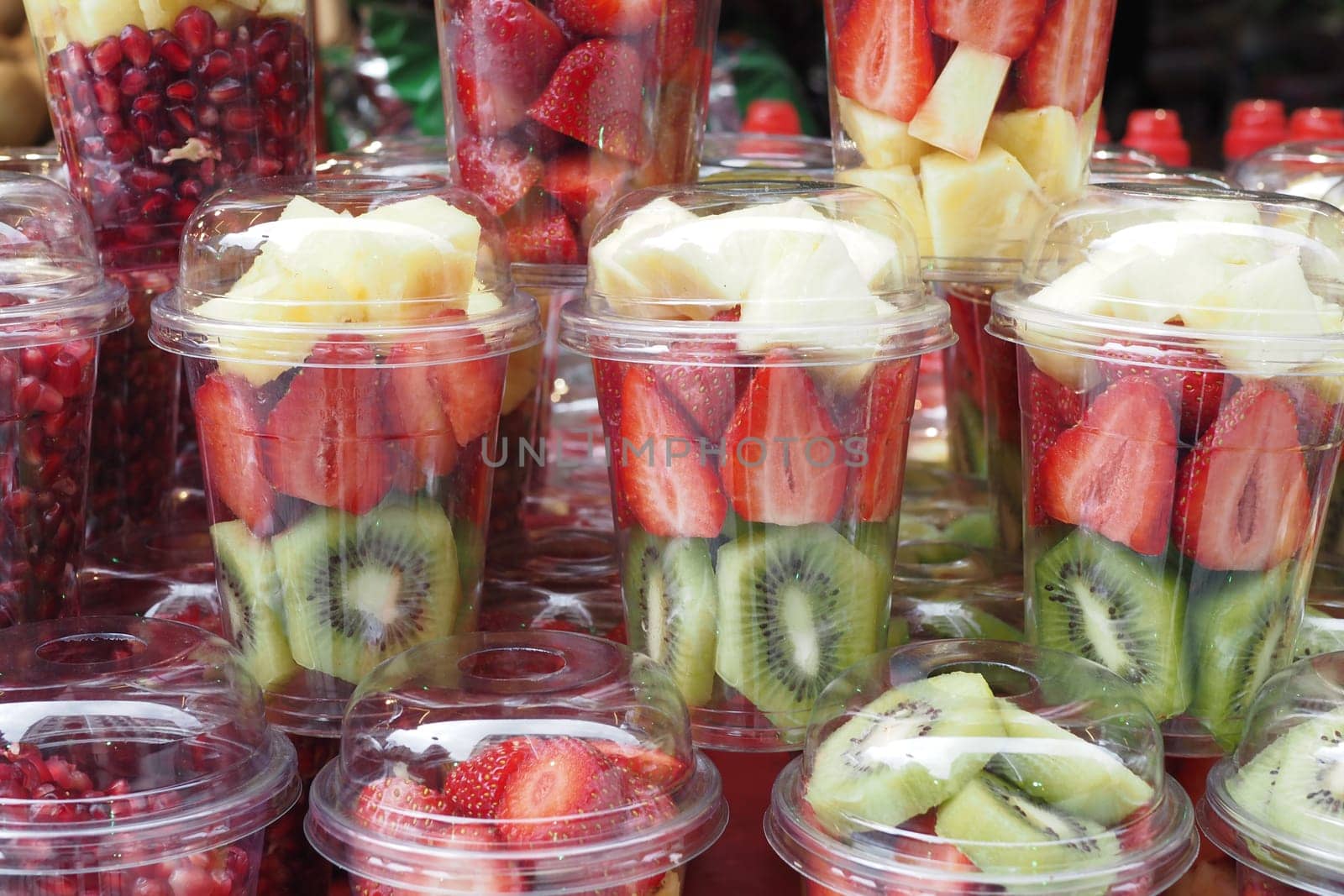 pineapple, kiwi and Strawberries in. plastic container selling at shop by towfiq007