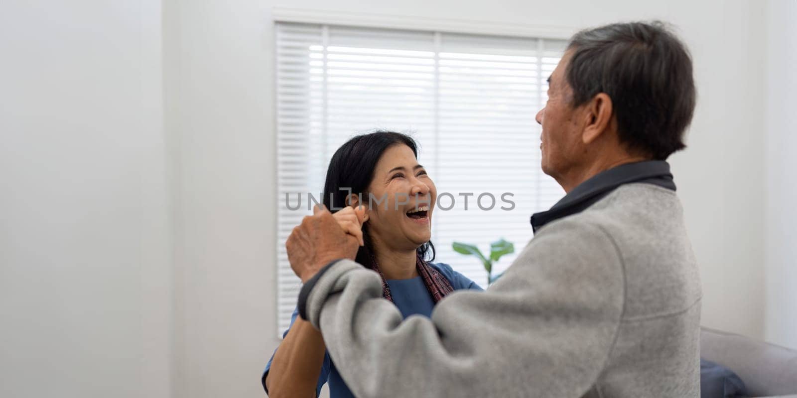 Holding hands, hug or happy old couple dancing for love, support or trust in marriage at home together.