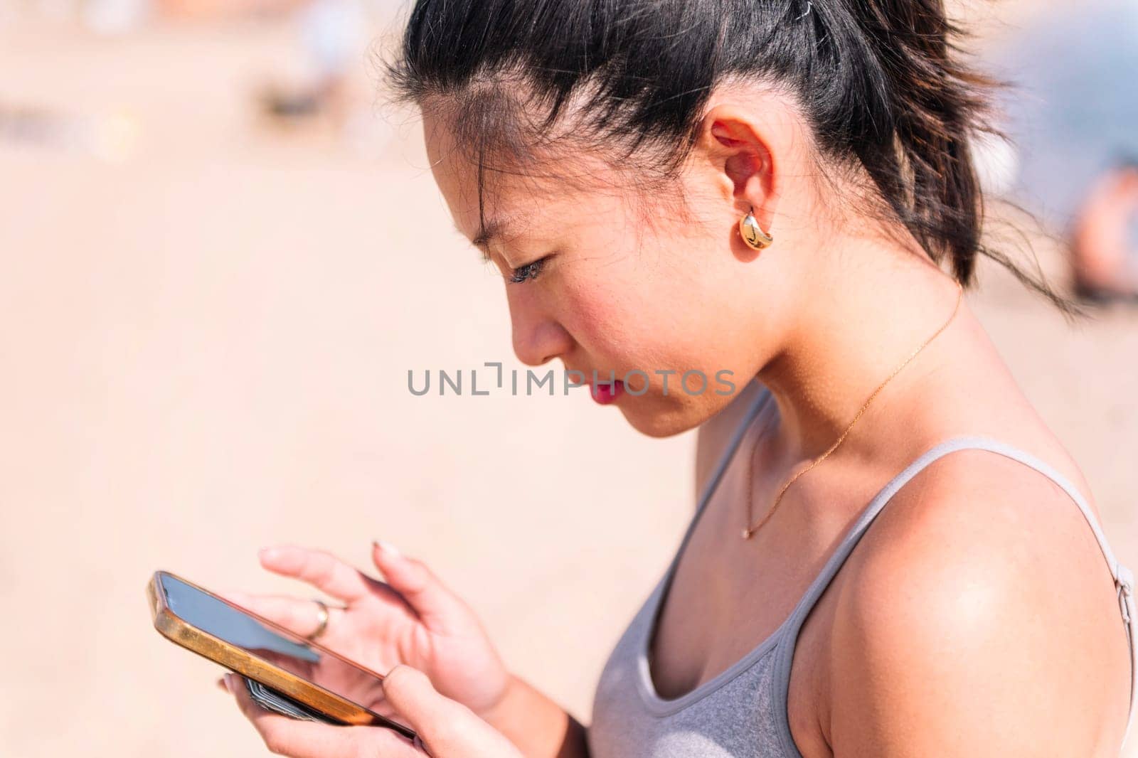 portrait of a young asian woman using mobile phone, concept of technology