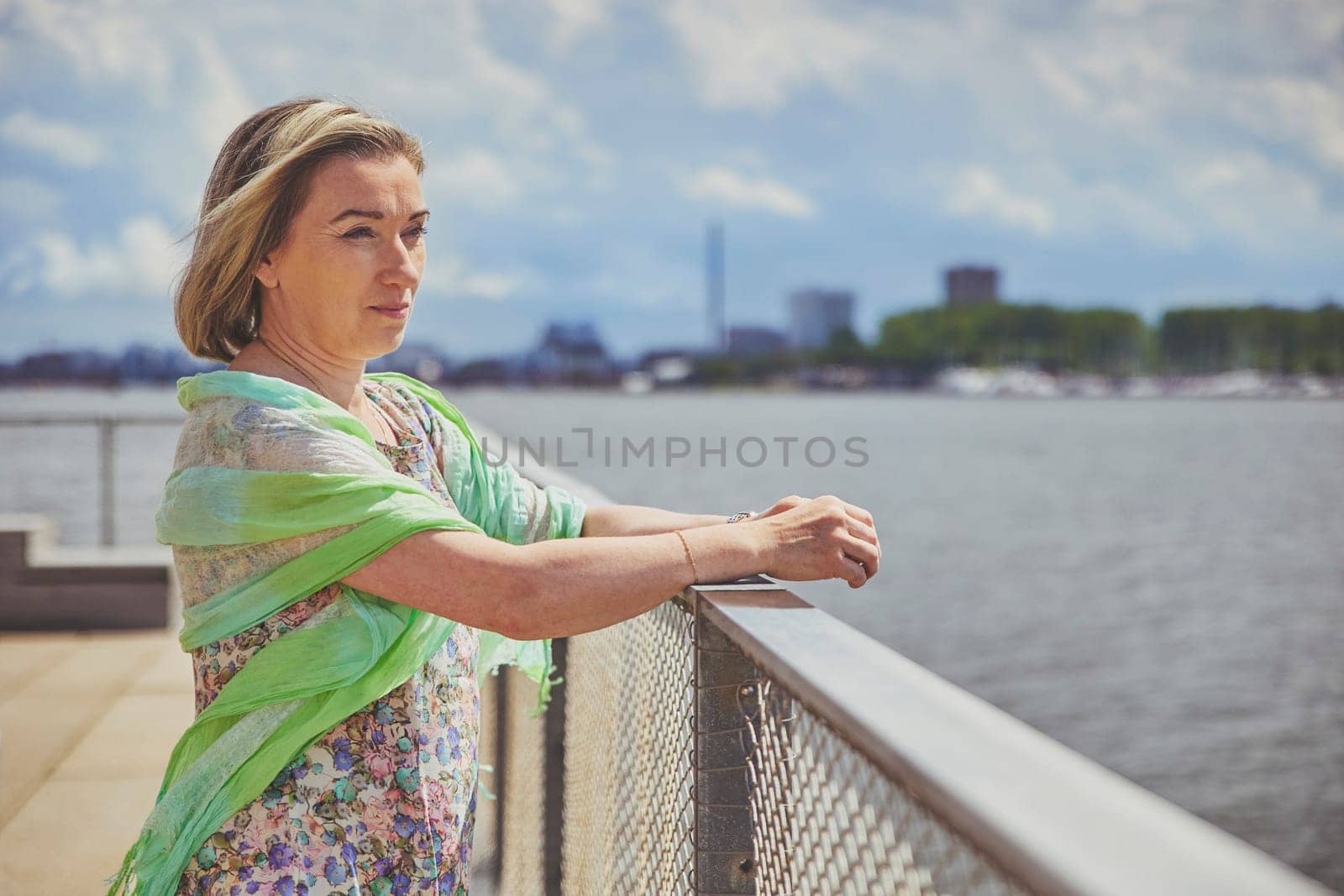 Aalborg, Denmark, July 10, 2022: Beautiful mature woman outdoors by Viktor_Osypenko