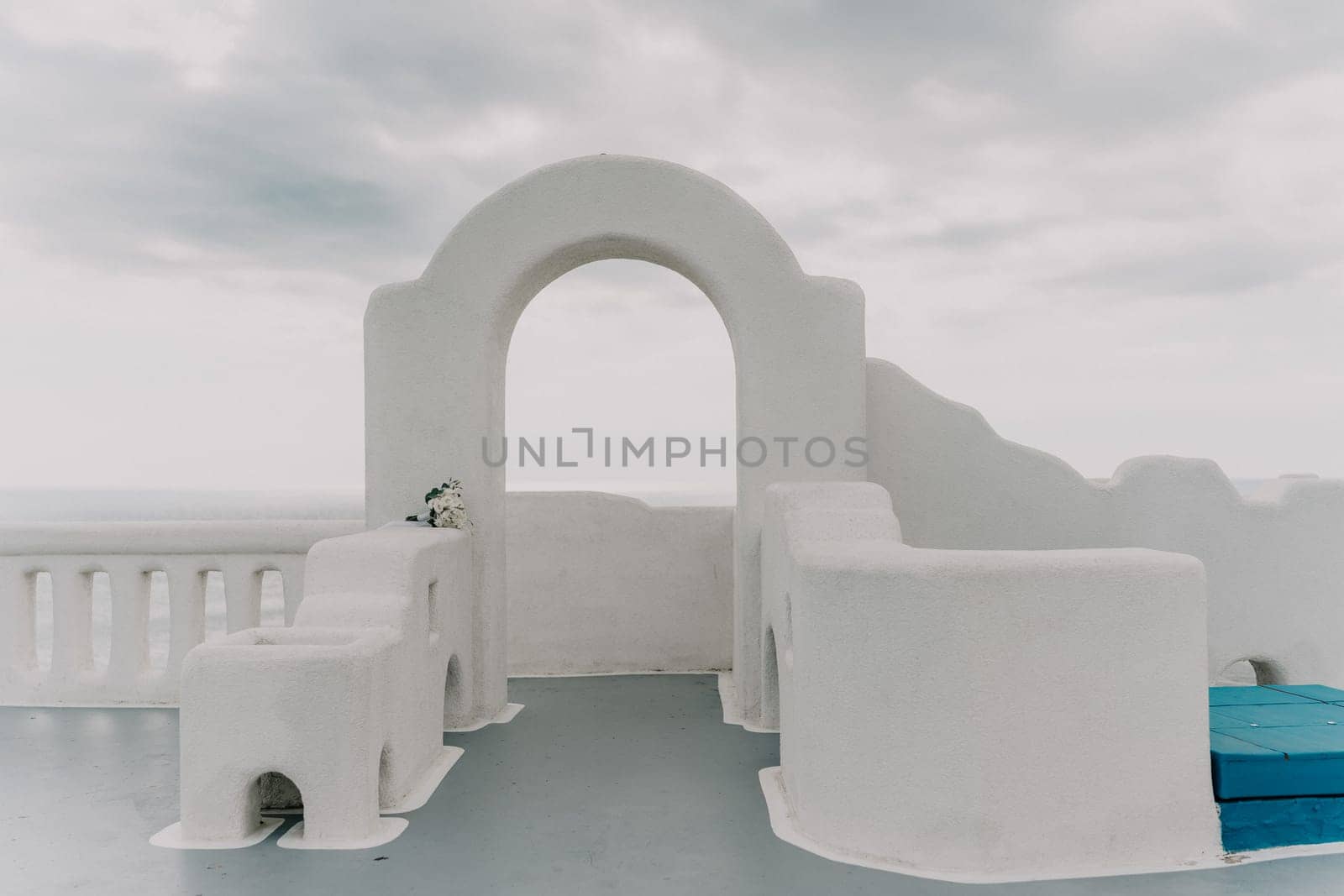 A white building with a blue roof and a blue bench by Matiunina