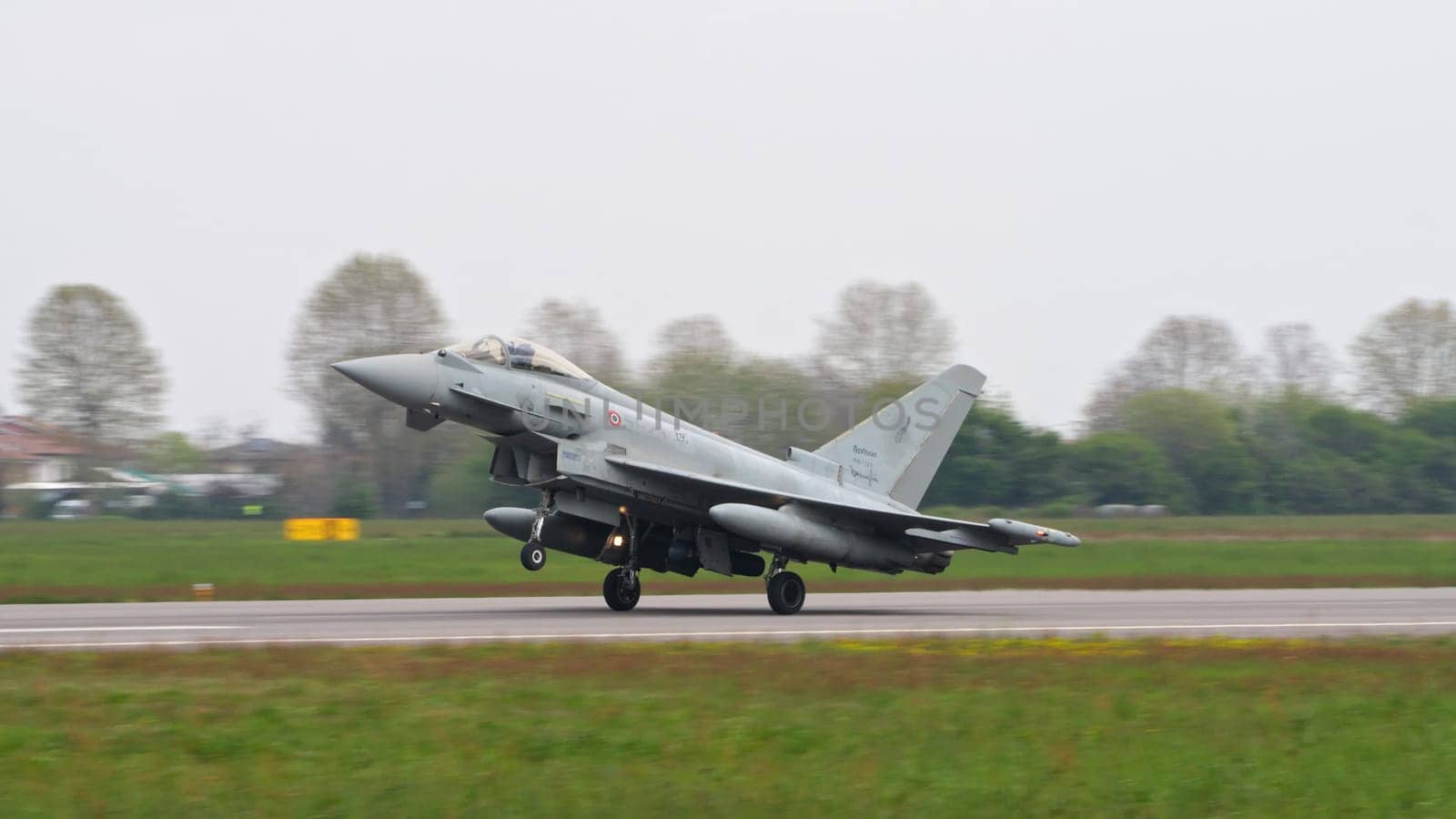 Istrana Italy April 5 2024: Fighter Jet Take Off from Military Airport Runway. Eurofighter Typhoon of Italian Air Force. Copy Space.