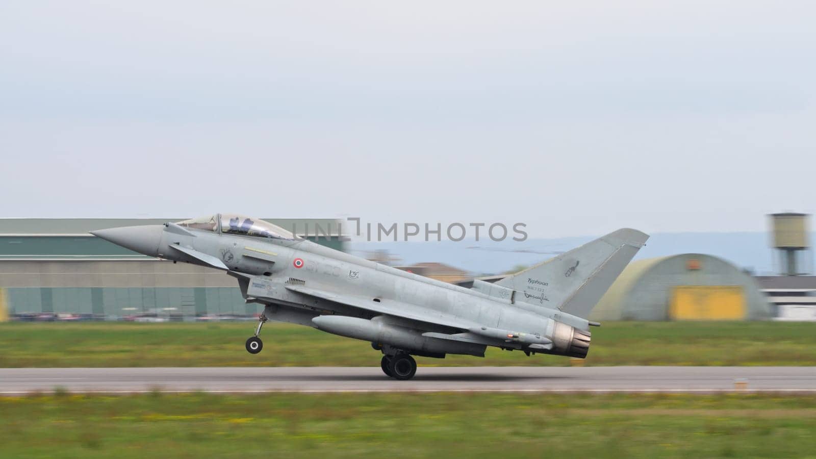 Istrana Italy April 5 2024: NATO Combat Aircraft Take Off for Air Defence Mission. Side View Close Up. Eurofighter Typhoon of Italian Air Force. Copy Space.
