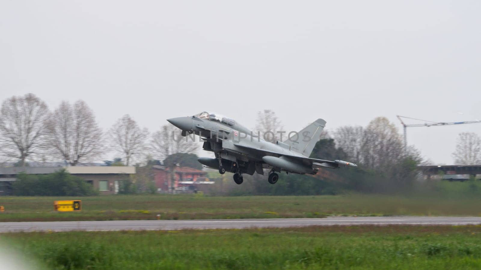 Istrana Italy April 5 2024: Military Aircraft Take Off in Bad Weather. Eurofighter Typhoon of Italian Air Force. Copy Space.