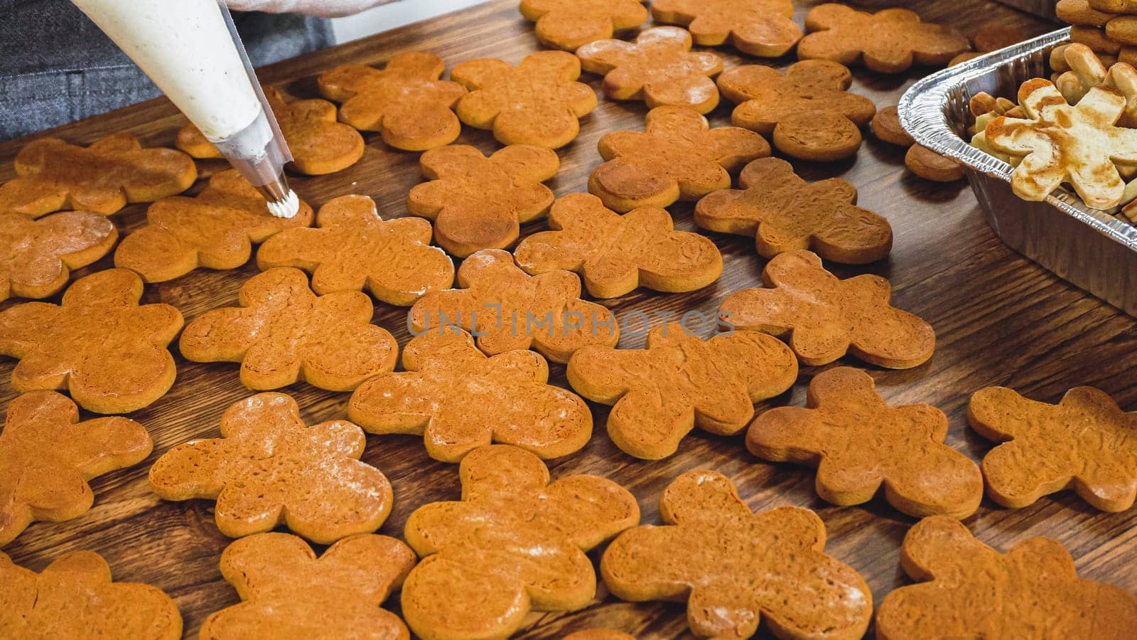 Crafting gingerbread cookie sandwiches with eggnog buttercream, presented on a rustic wooden table for Christmas gifting.