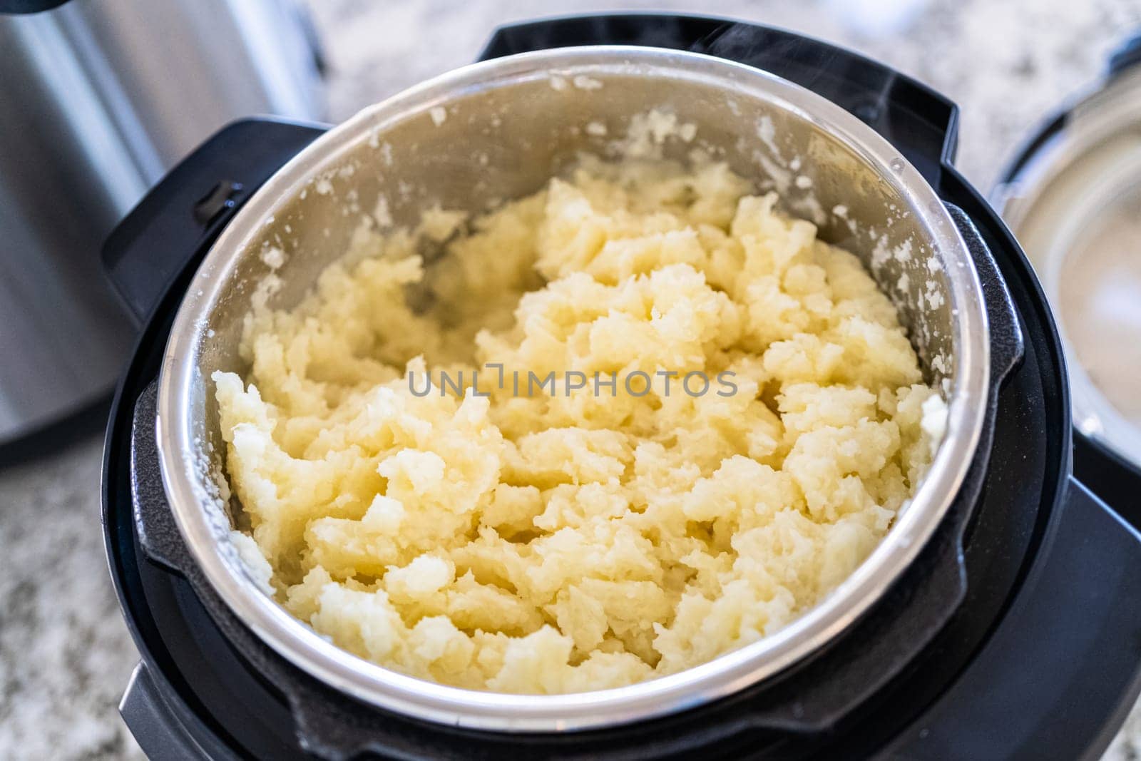 Whipping Up Creamy Mashed Potatoes in Modern Kitchen by arinahabich