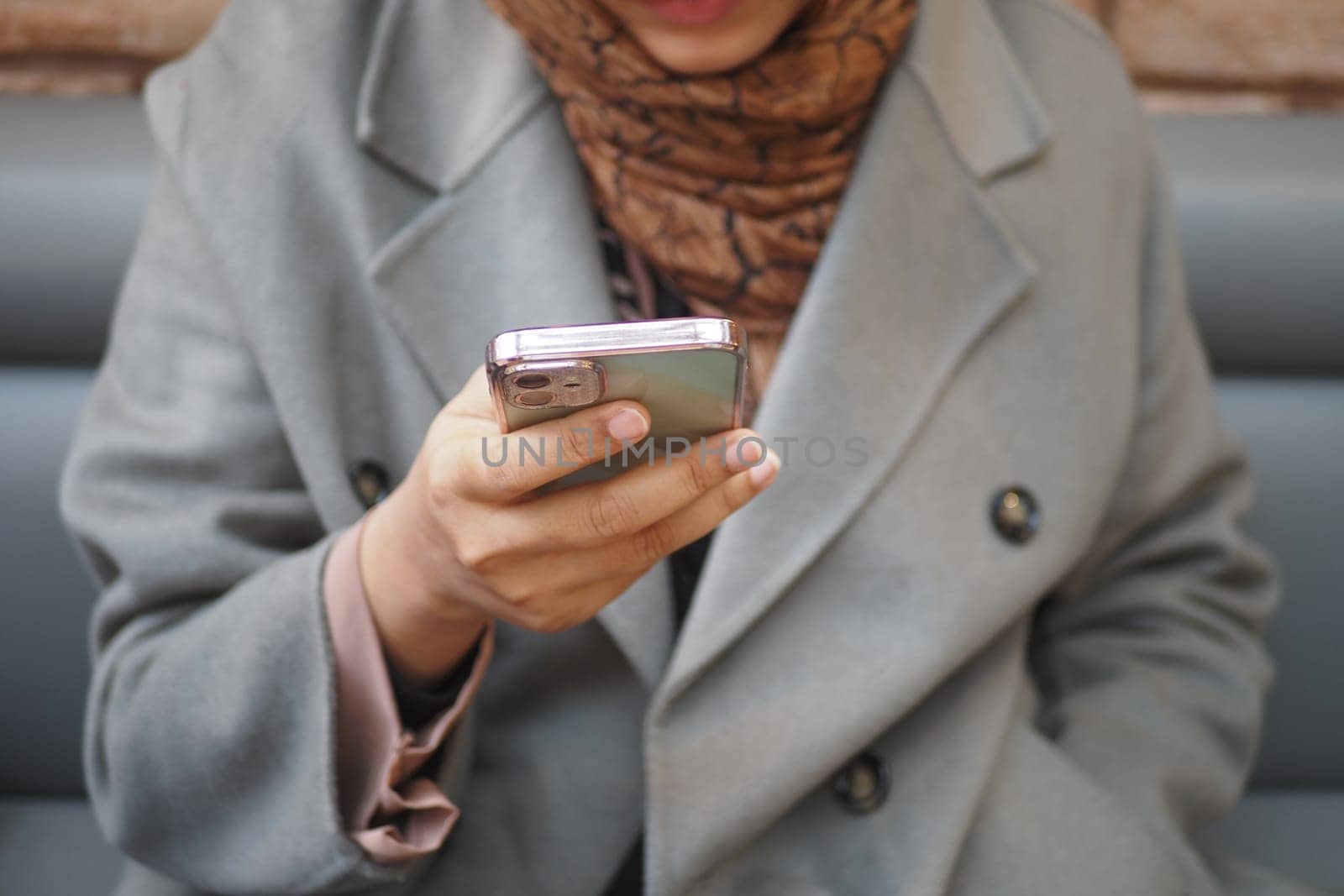 women hand holding smart phone sitting on cafe by towfiq007