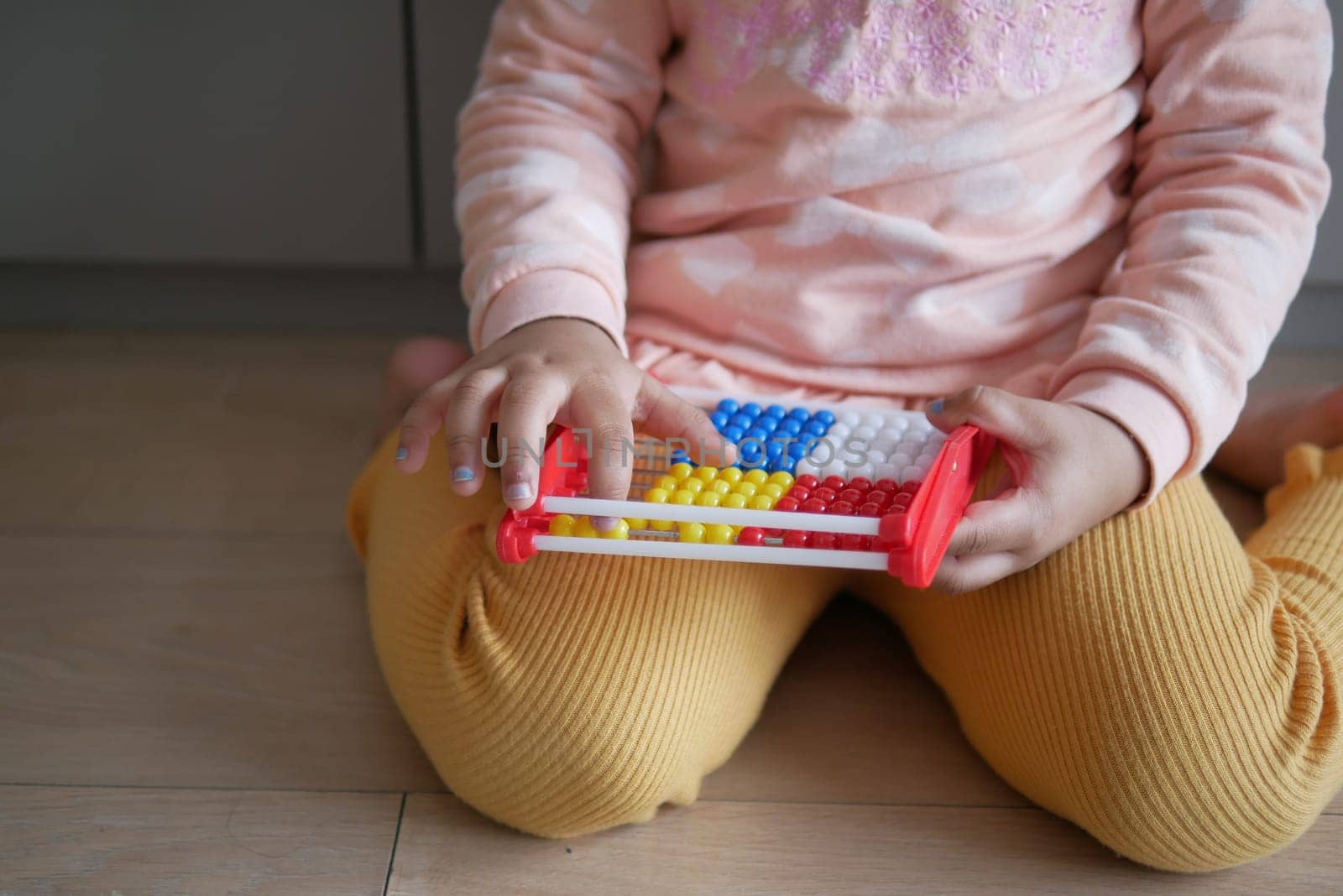 toddler playing with counting math learning toy