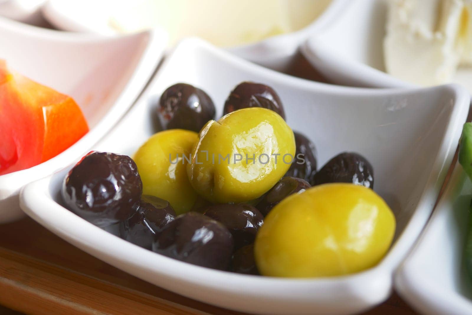 Collection of black and green olives with leaves