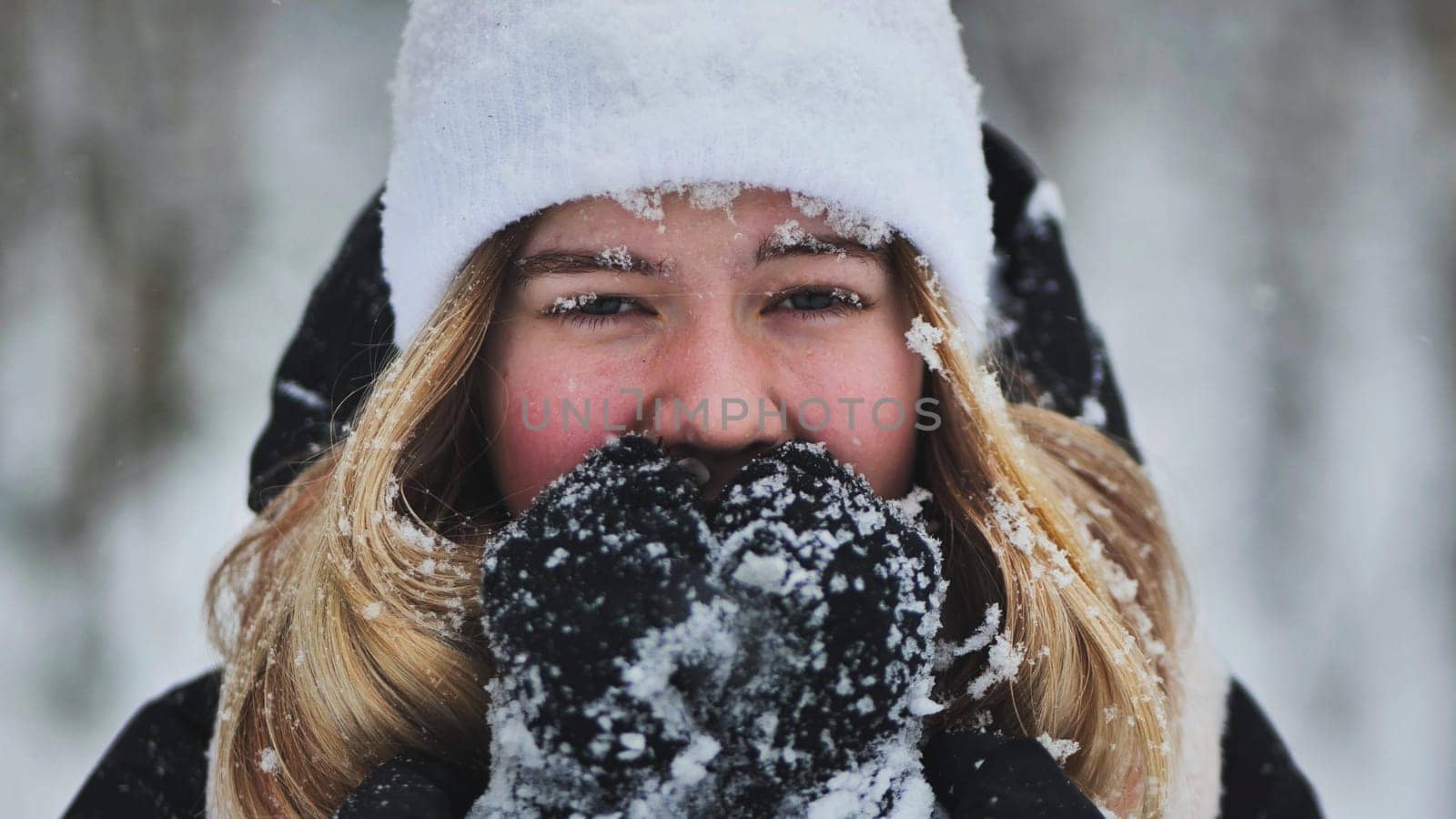 A young girl freezes in the woods in winter. by DovidPro