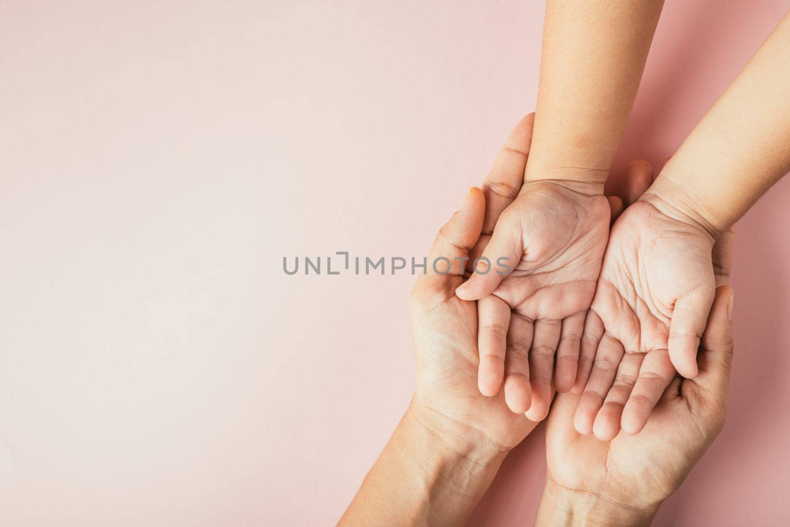 Family day concept, Parents and kid holding empty hands together isolated on color background. Celebrating togetherness and support. by Sorapop