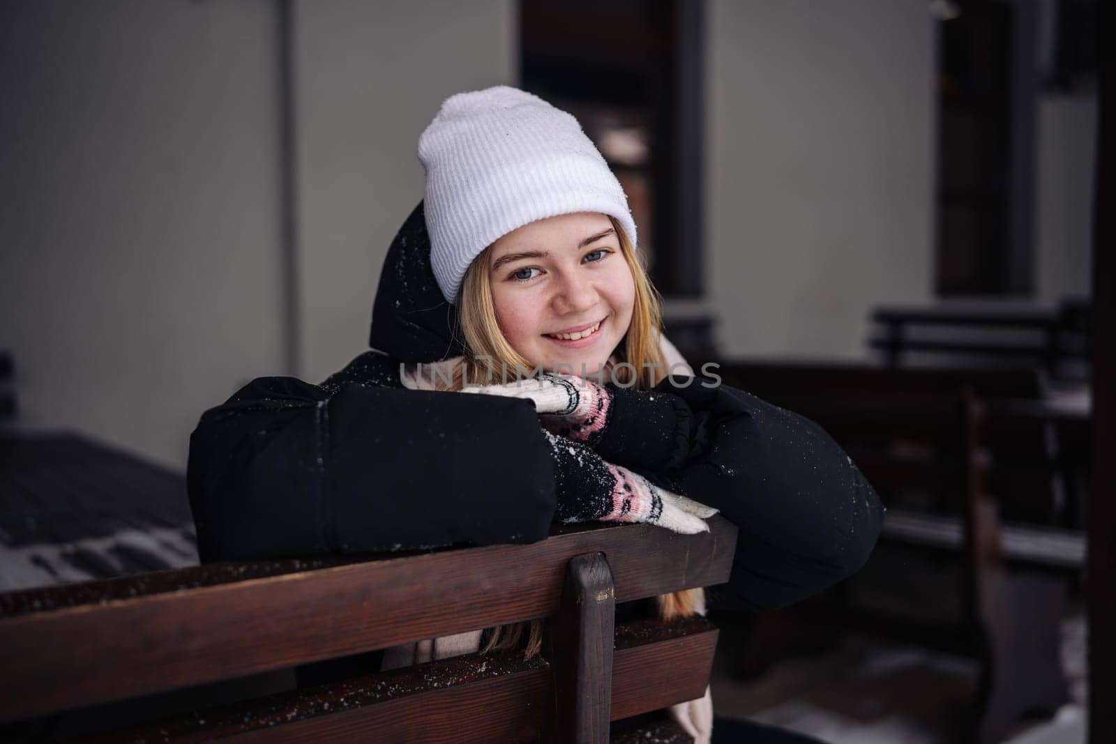 Portrait of a teenage girl outside a cafe in winter. by DovidPro