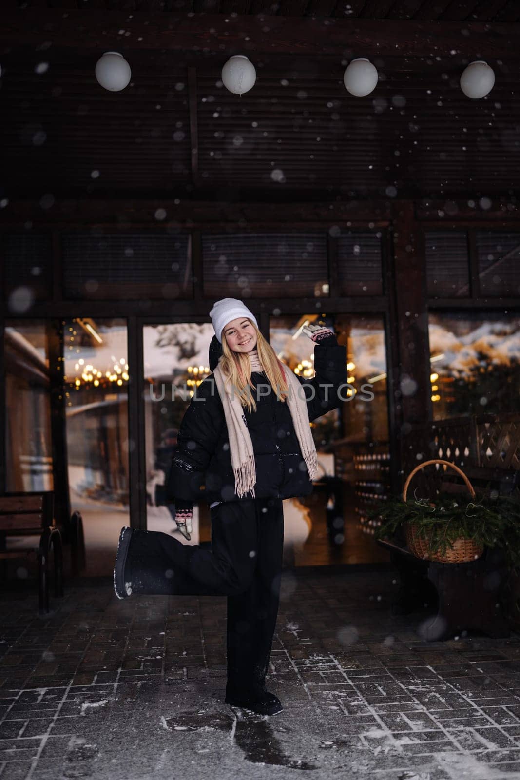 Portrait of a teenage girl outside a cafe in winter. by DovidPro