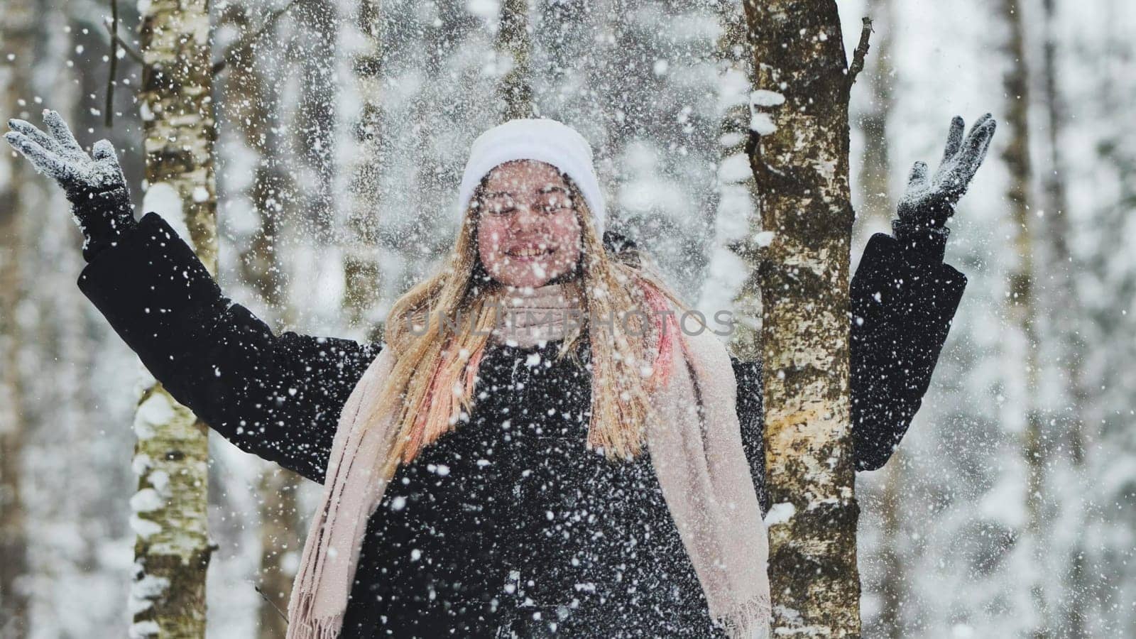 Teenage girl playing with snow. by DovidPro