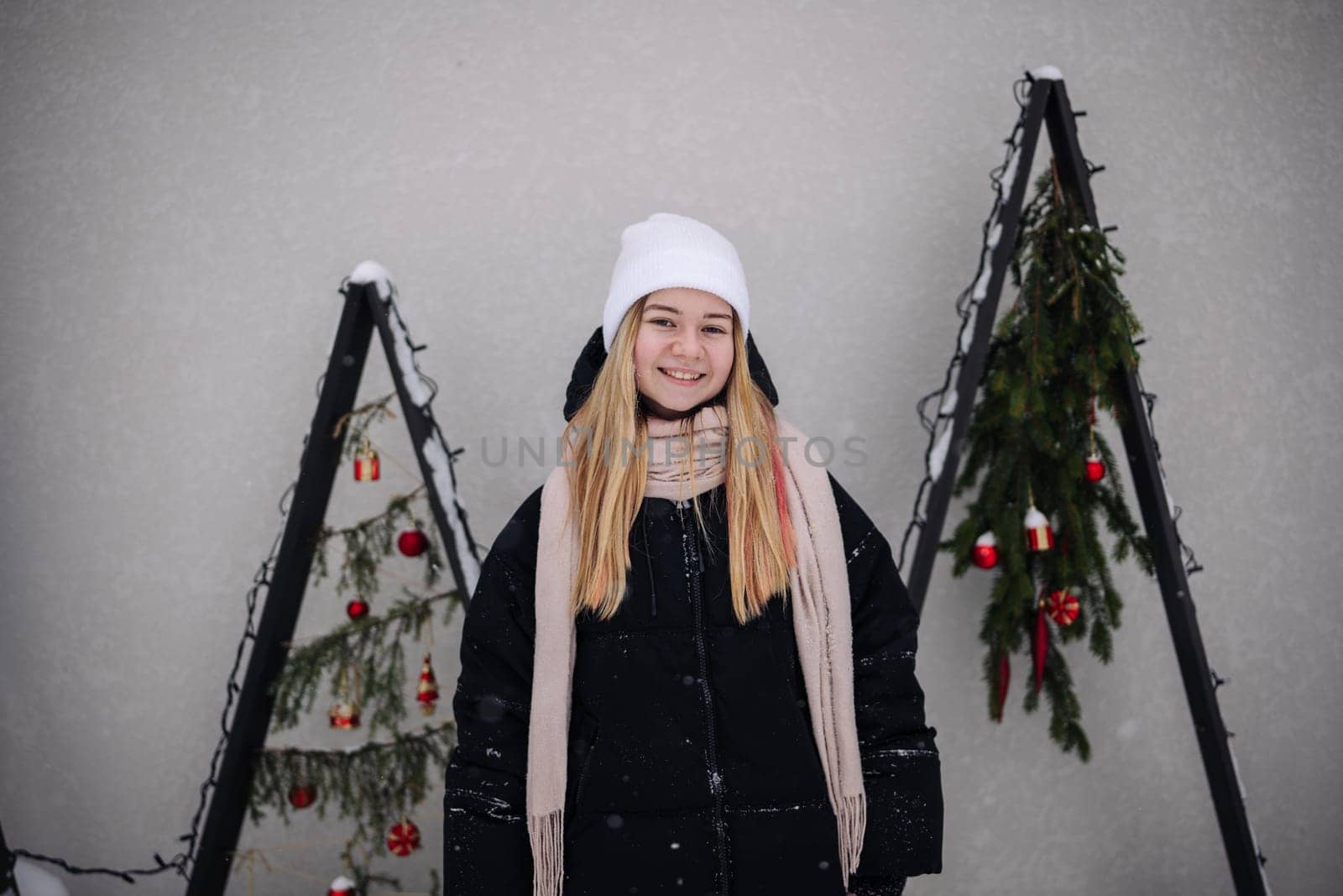 Portrait of a teenage girl by the artificial Christmas trees. by DovidPro