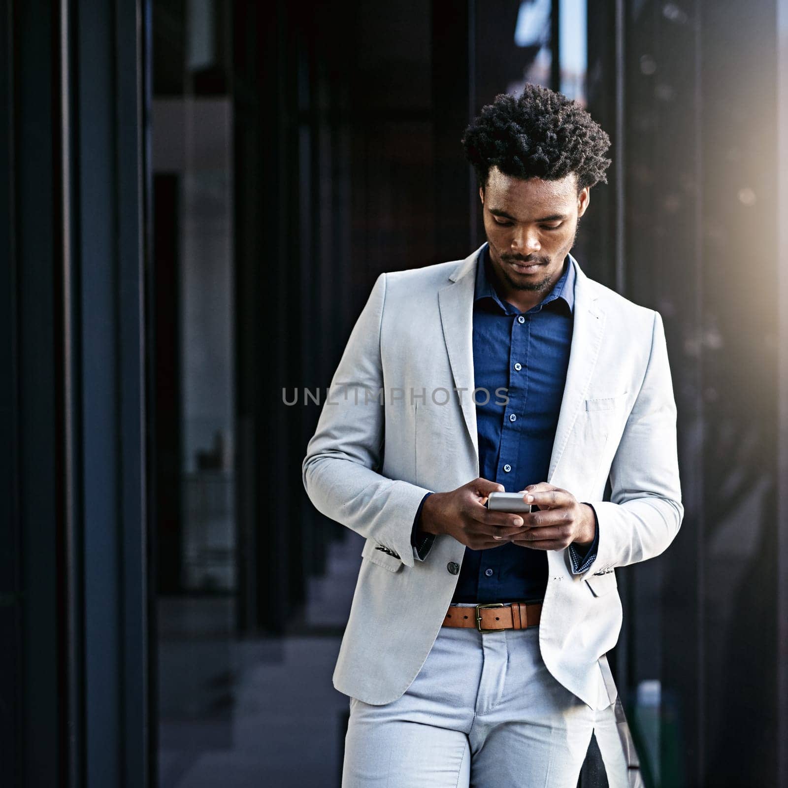Businessman, typing and balcony with phone for communication, social media or news in city. African man or employee on mobile smartphone app for online chatting, texting or research in an urban town.