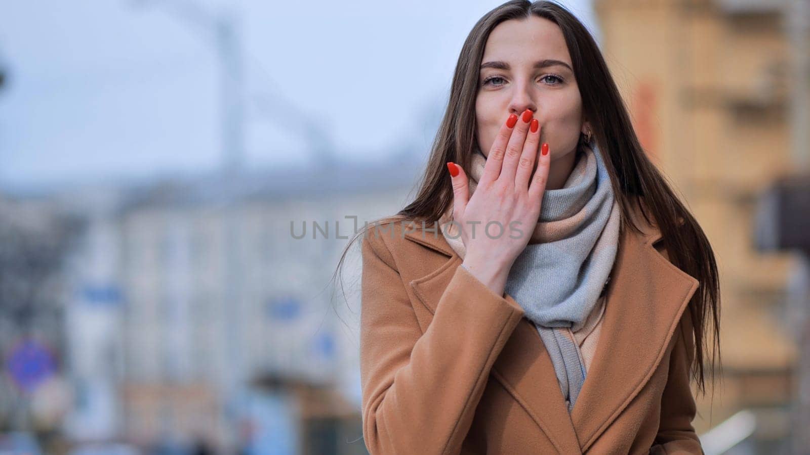 The young girl sends an air kiss to us