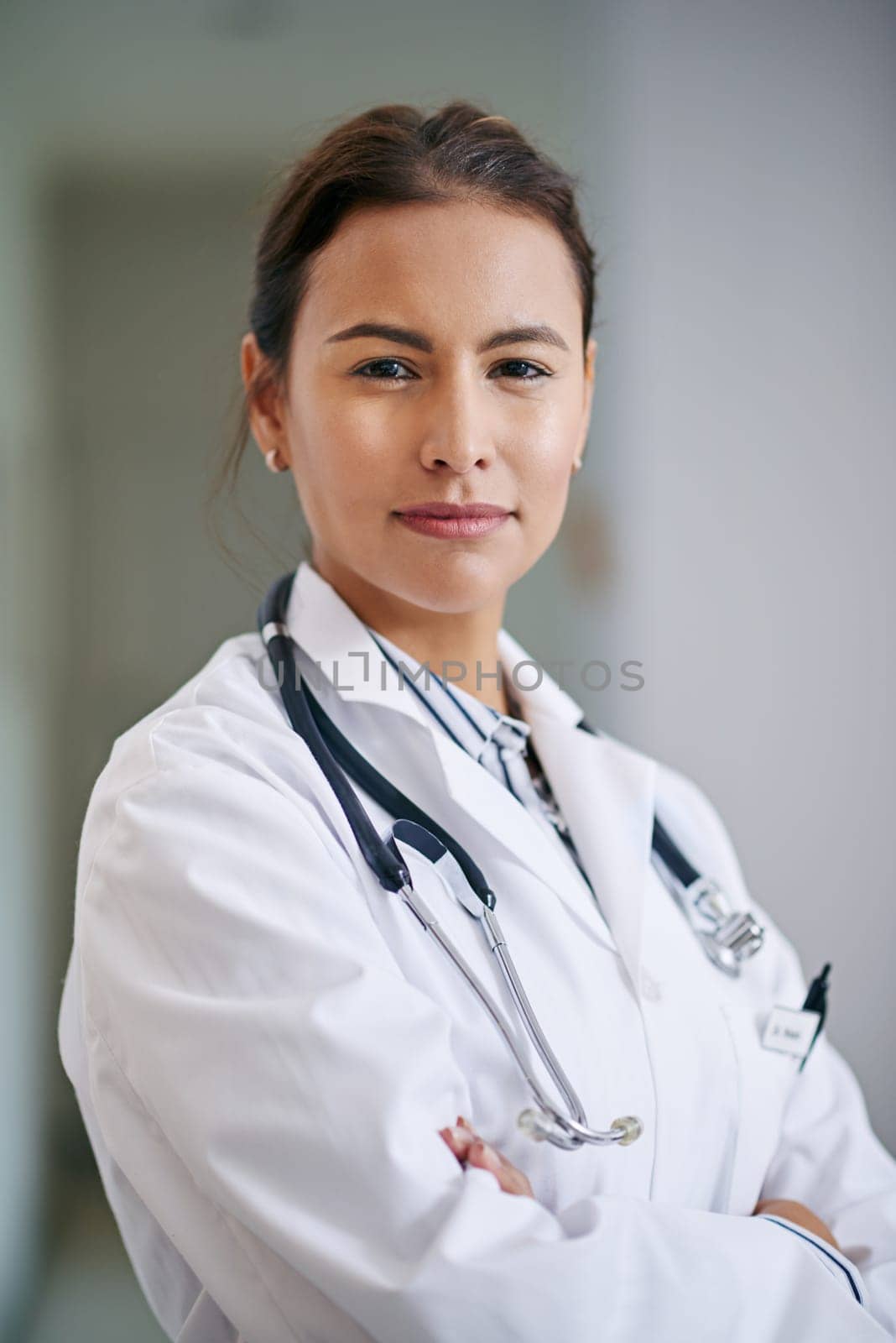 Woman, portrait and doctor with confidence in hospital, clinic and wellness facility with consultant in medical career. Female person, cardiologist and healthcare professional for consulting by YuriArcurs