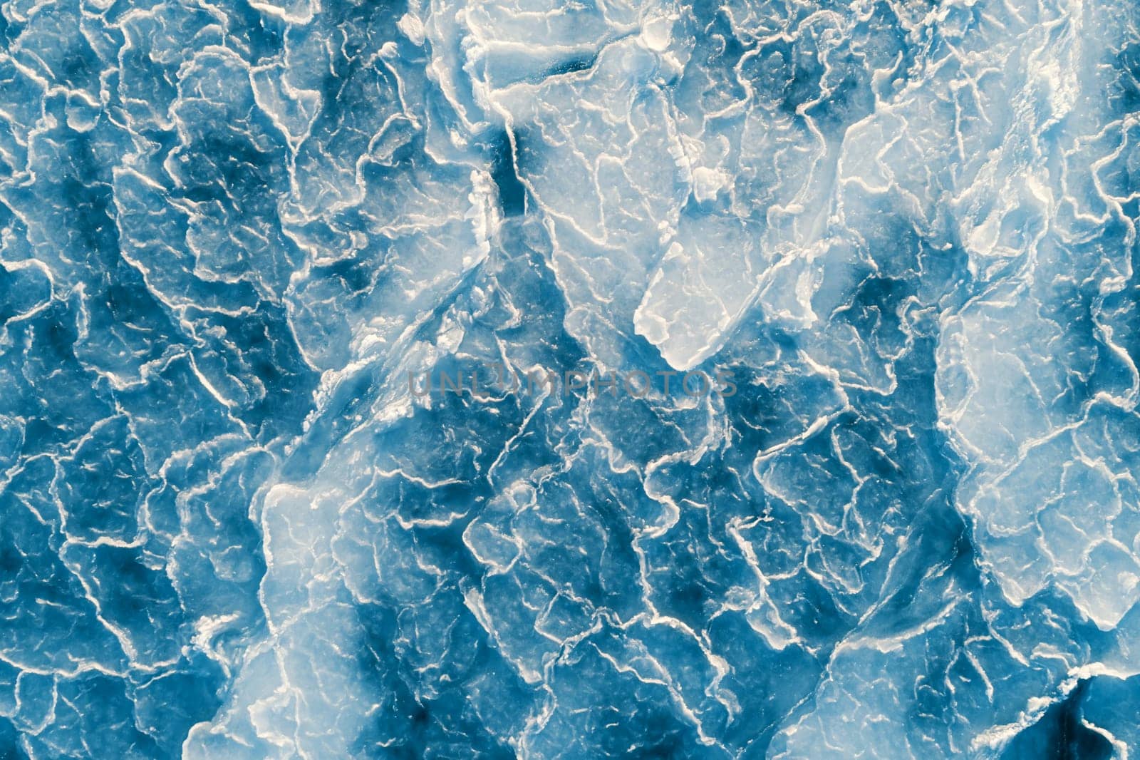 Aerial top down view of ice surface. Frozen sea surface texture by Busker