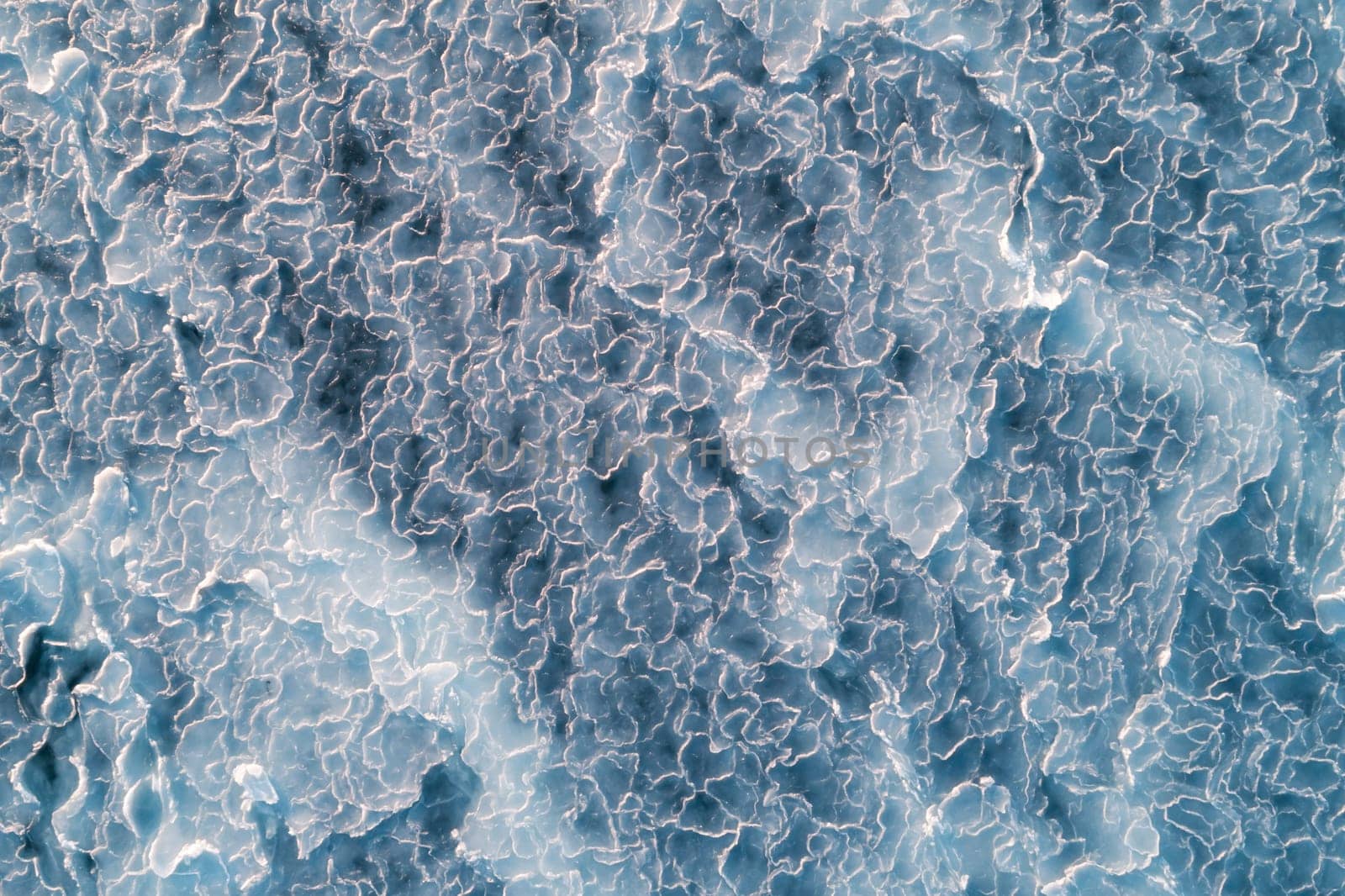 Aerial top down view of ice surface. Frozen sea surface texture