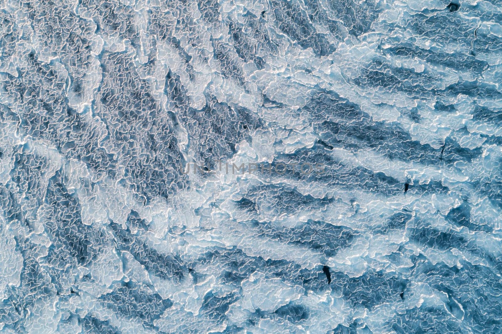 Aerial top down view of ice surface. Frozen sea surface texture by Busker