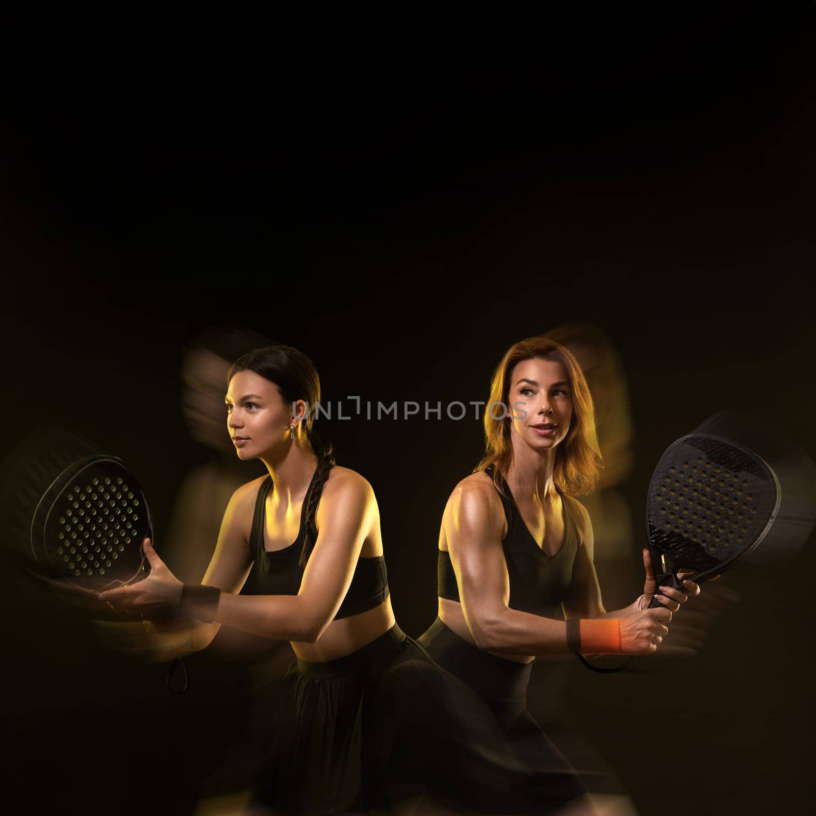 Padel tennis doubles. Two athletes players with racket. Women with paddle racket on court. Sport concept. Download a high quality photo for the design of a sports app by MikeOrlov