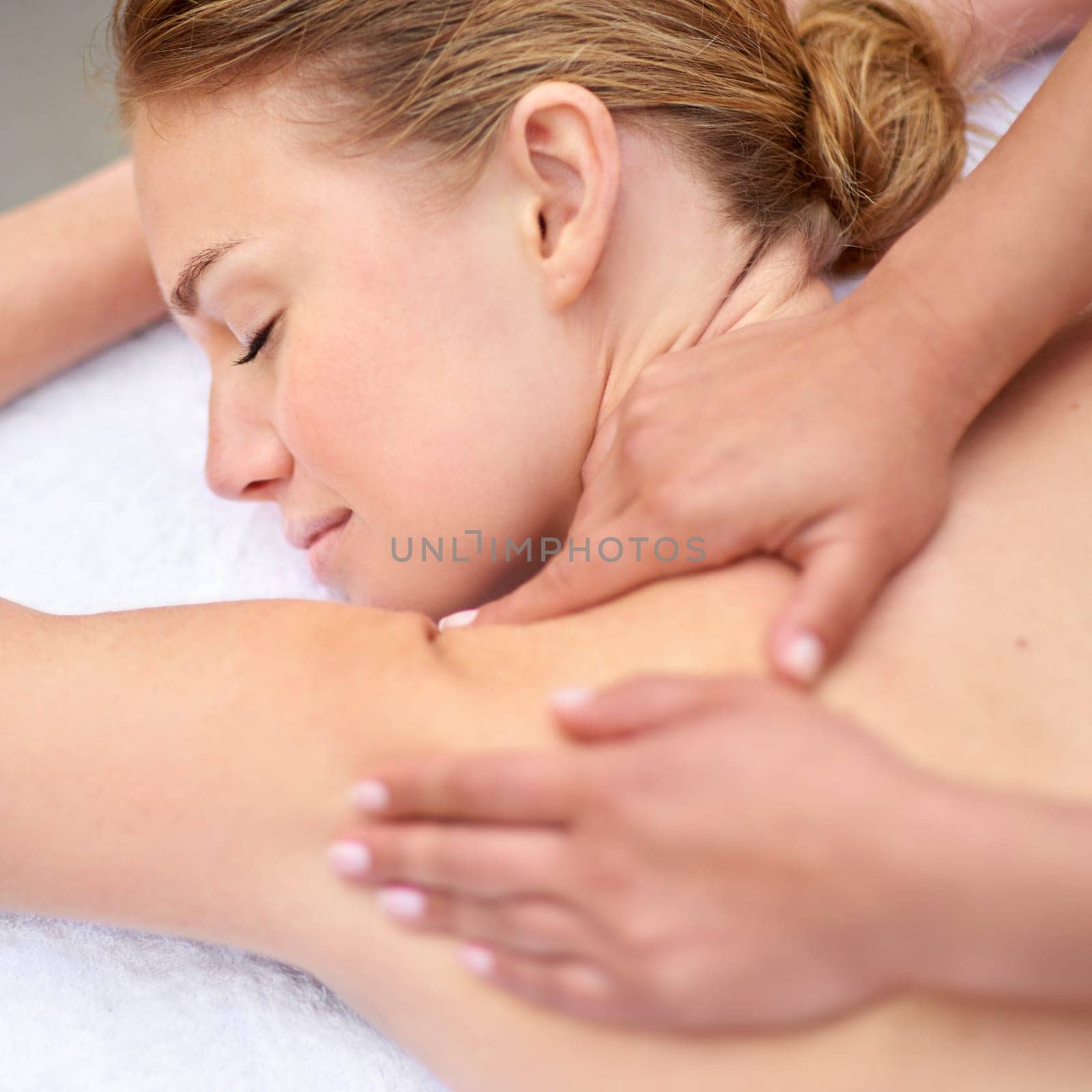 Massage, woman and spa for health, wellness and relaxation in muscles, back and neck for self care. Female person, physical therapy and detox for body with smile, calm and happiness on vacation.
