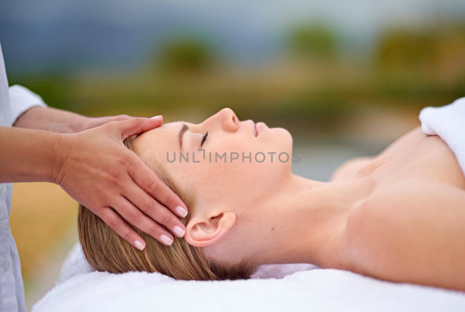 Woman, face and hands with massage in spa for luxury skincare, wellness and relax. Facial care, masseuse and dermatology outdoor with peace, detox treatment and cosmetic therapy for salon aesthetic by YuriArcurs