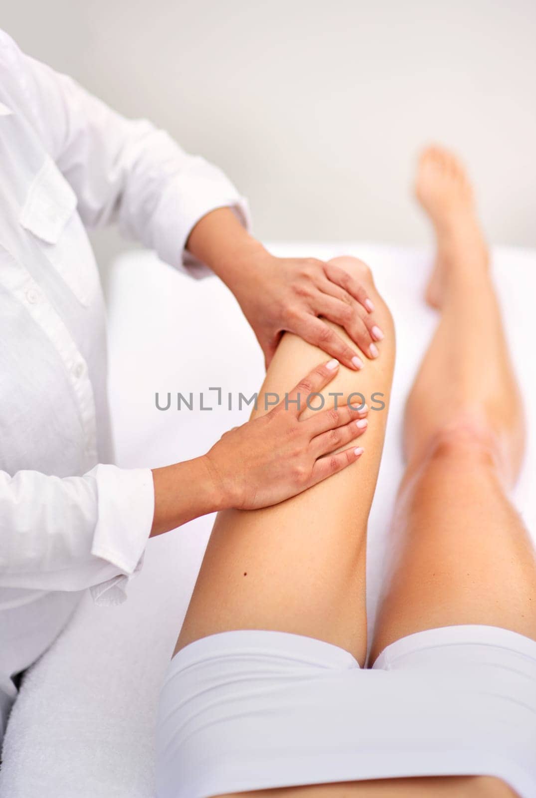 Woman, spa and leg massage for treatment, health and physical therapy for wellbeing break. Lady, detox and muscle wellness for body care, stress relief and zen for peaceful beauty or skincare.