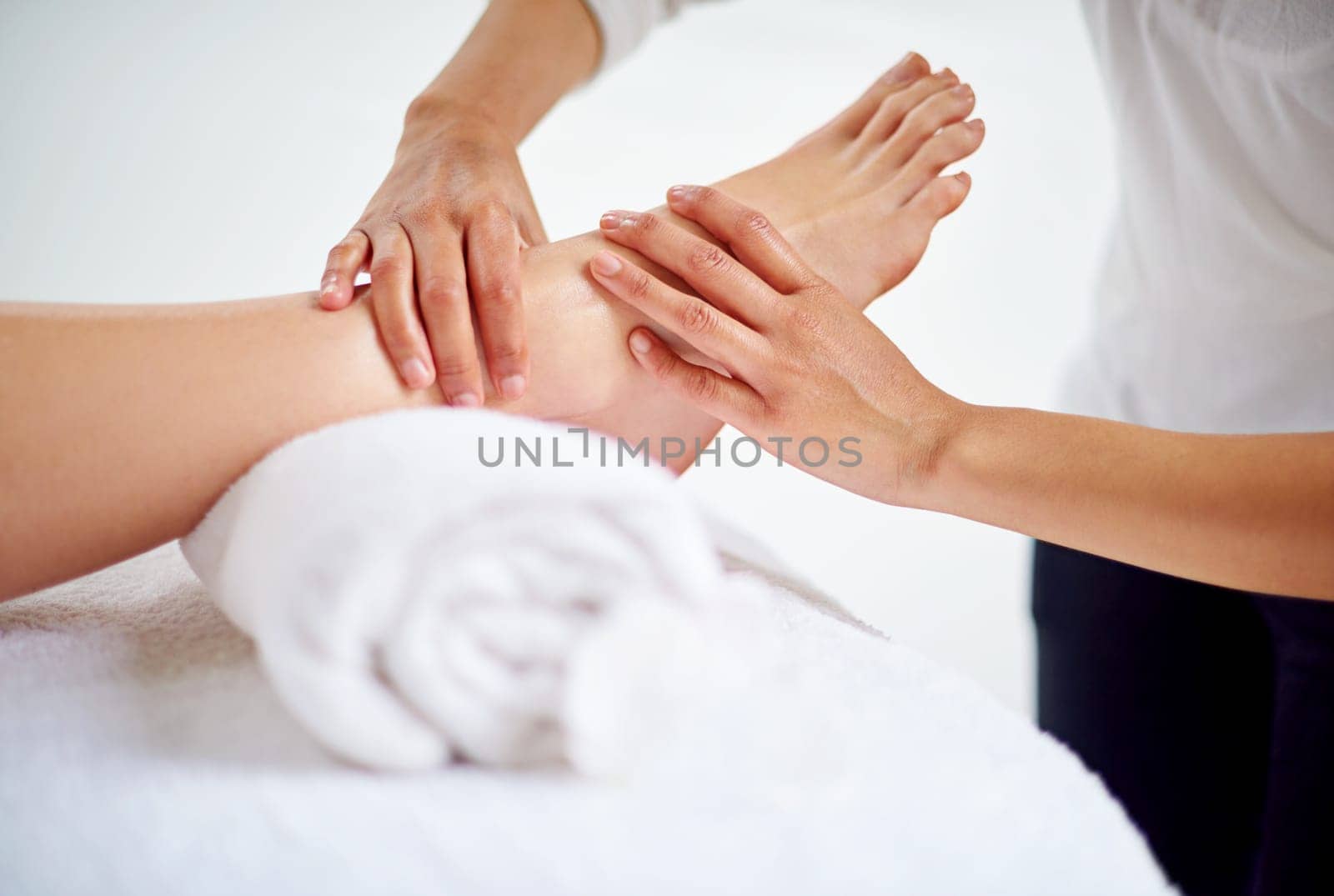 Woman, feet and massage table in spa, therapy and self care for body wellness and resting for tension. Comfortable and resort with client, stress free and healing, calm session and cosmetology.