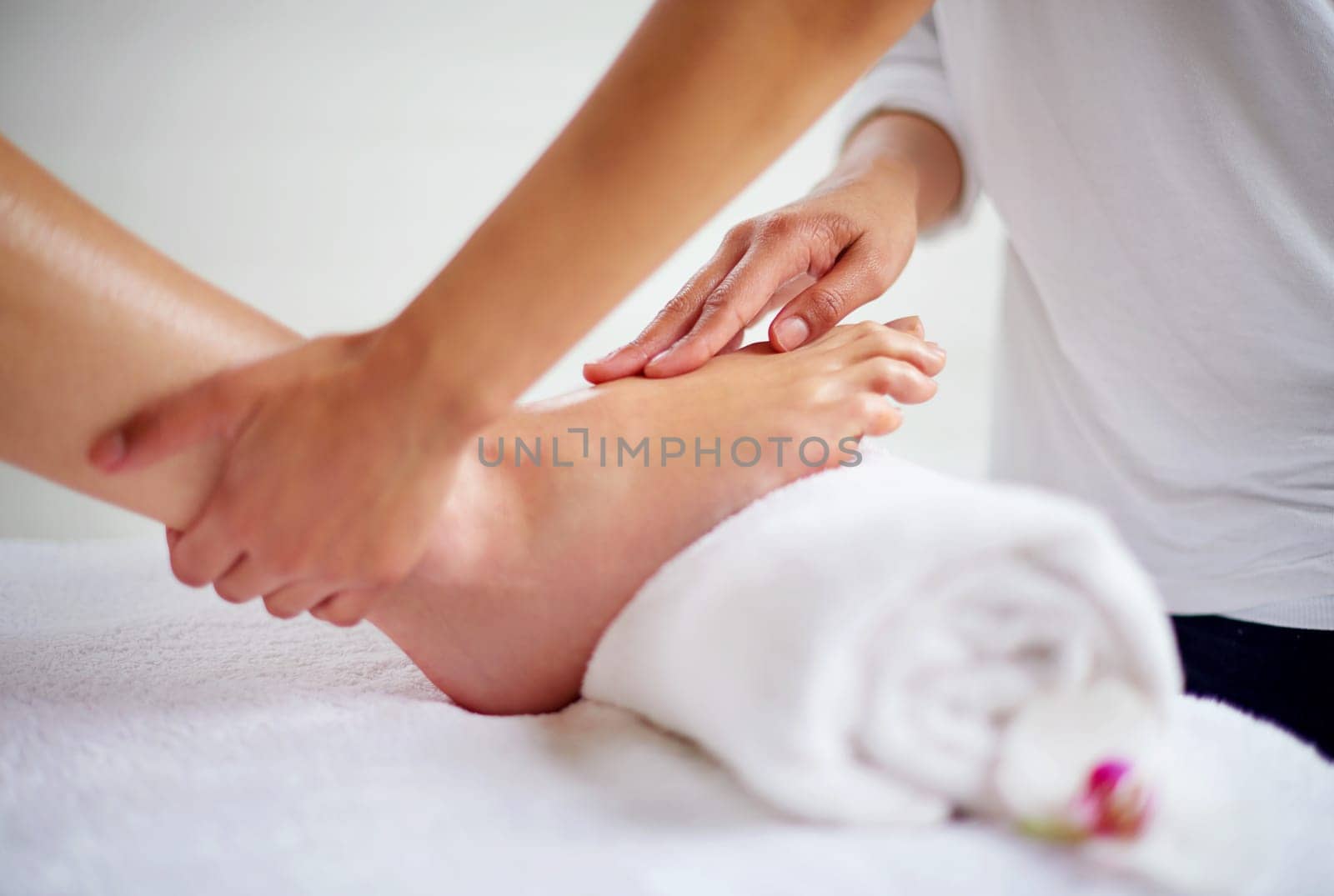 Foot, hands and pressure massage with spa for treatment, beauty and skincare at luxury resort with wellness. Pedicure, cosmetics and people for physical therapy with healing for self care and relief by YuriArcurs