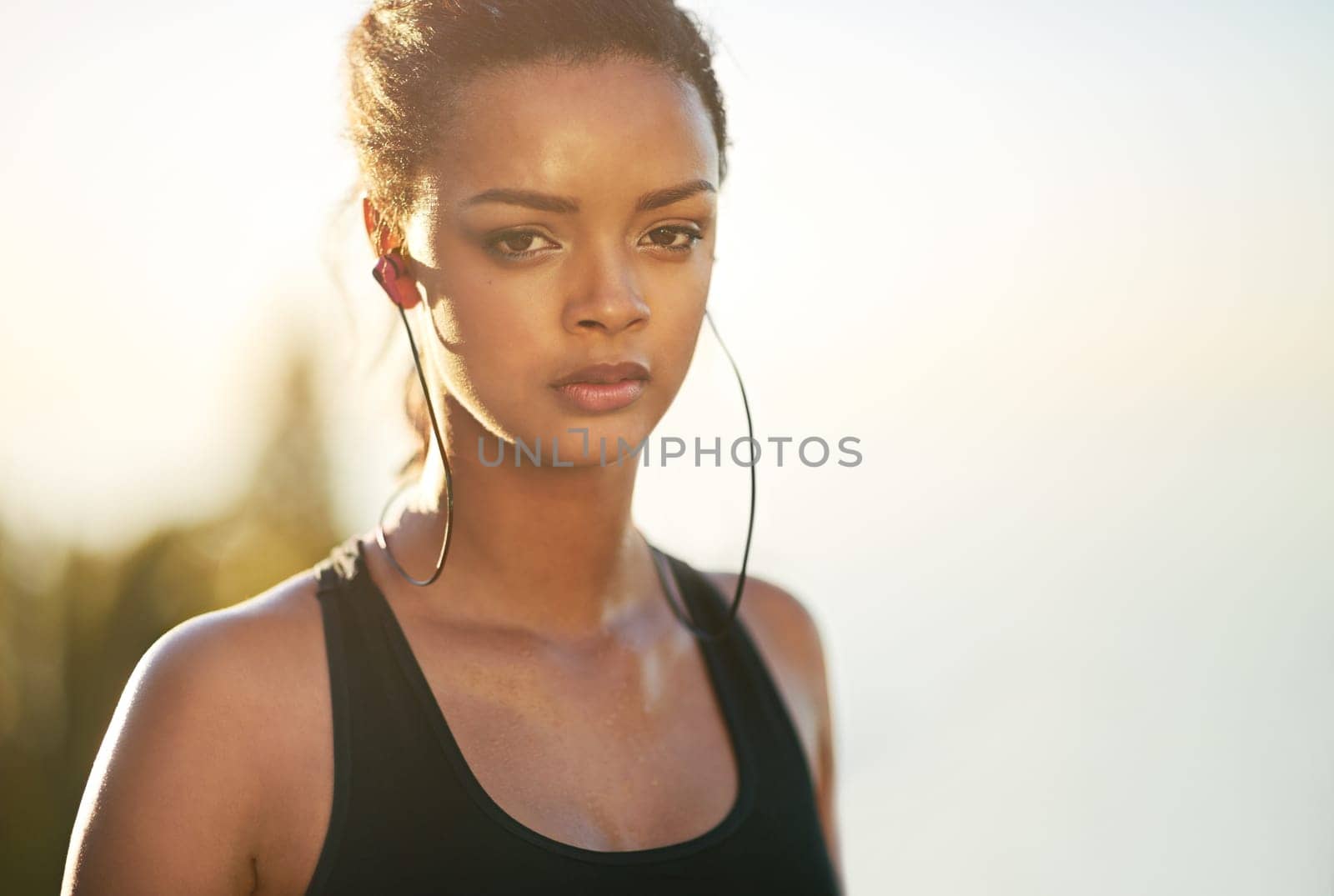 Portrait, woman and streaming music on run for wellness, health and lifestyle on break in Brazil. Athlete, outdoors and training in sportswear for cardio, workout and fitness for marathon in city.