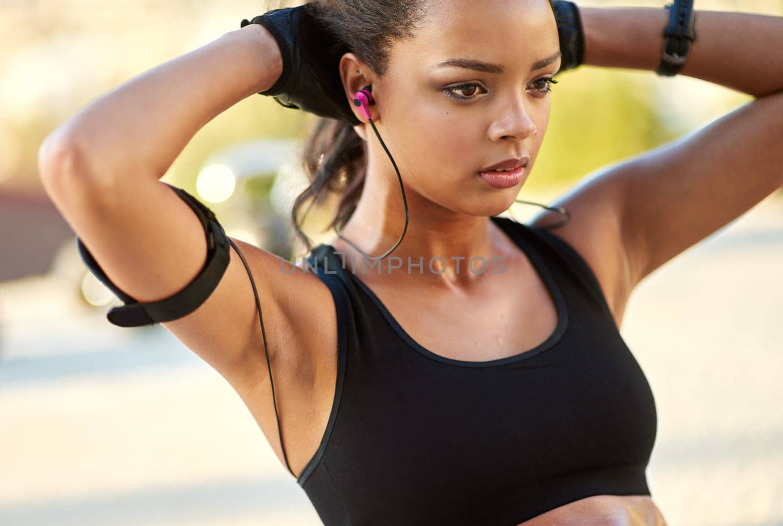 Fitness, outdoor and woman with earphones for sit up exercise for health, wellness and body training. Sports, nature and female athlete listening to music, radio or podcast for abdomen workout